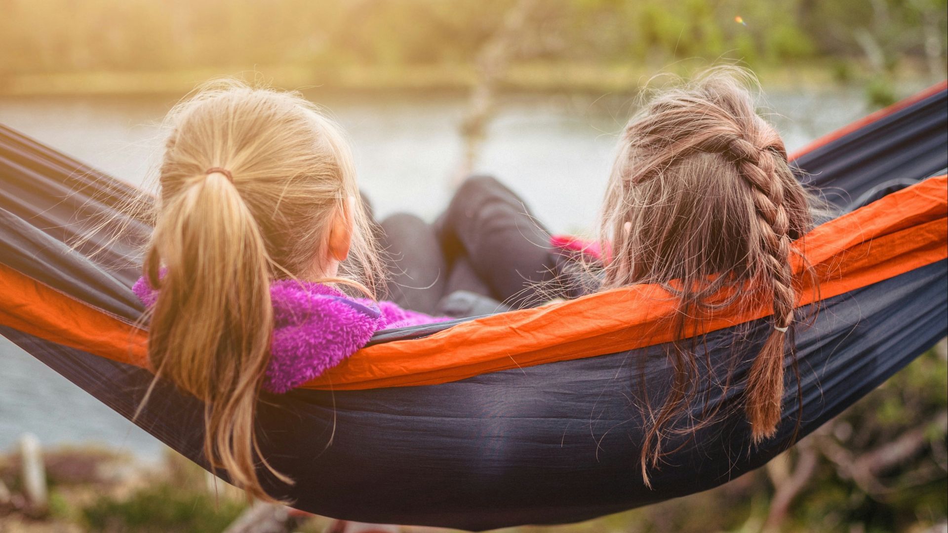 two women lying on hammock