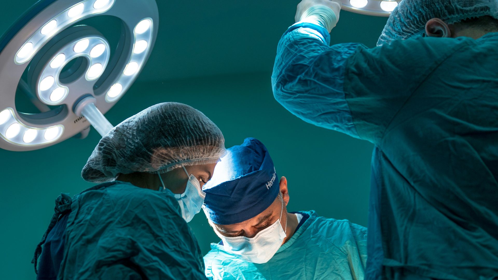 a group of doctors performing surgery on a patient