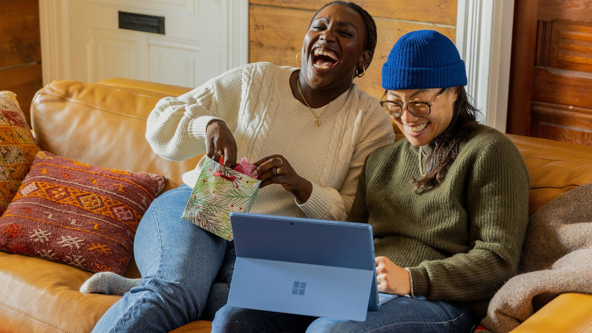 a person sitting on a couch with a laptop
