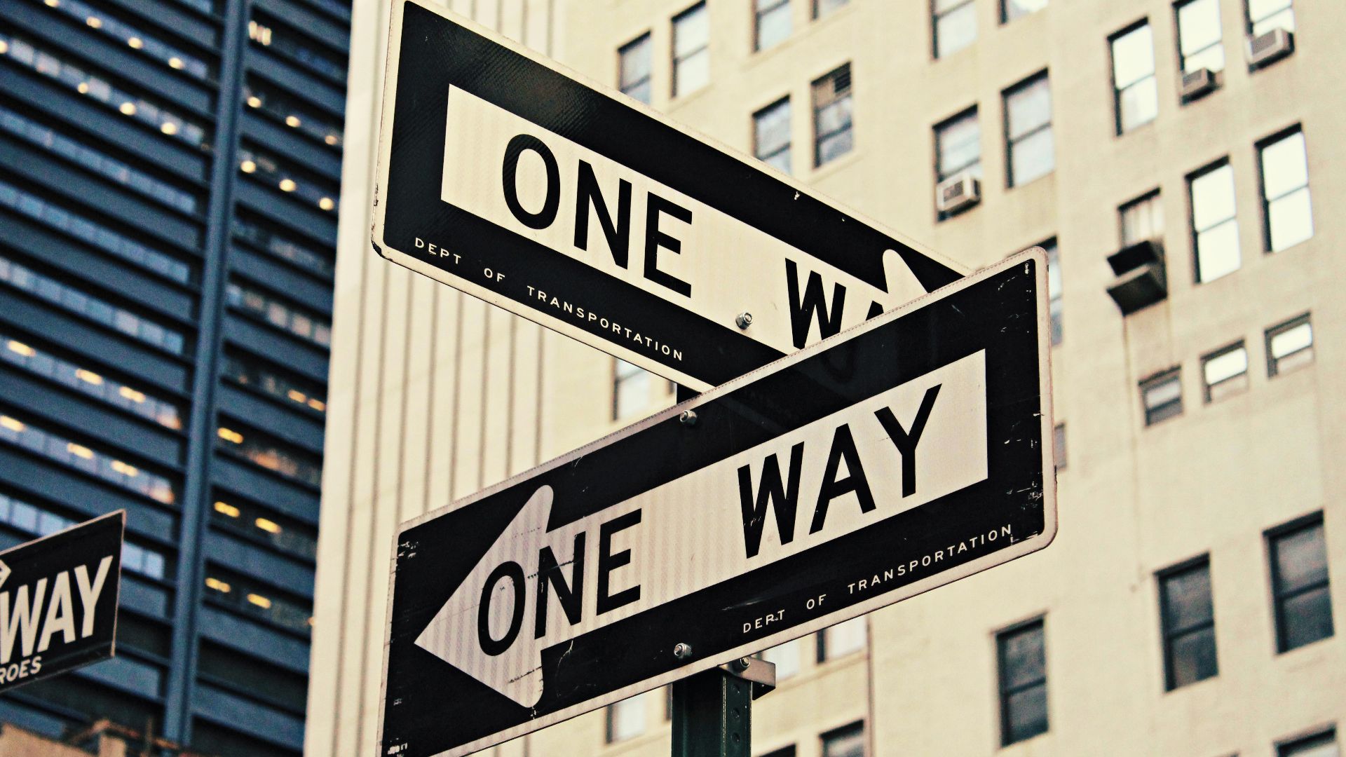white and black One Way-printed road signages
