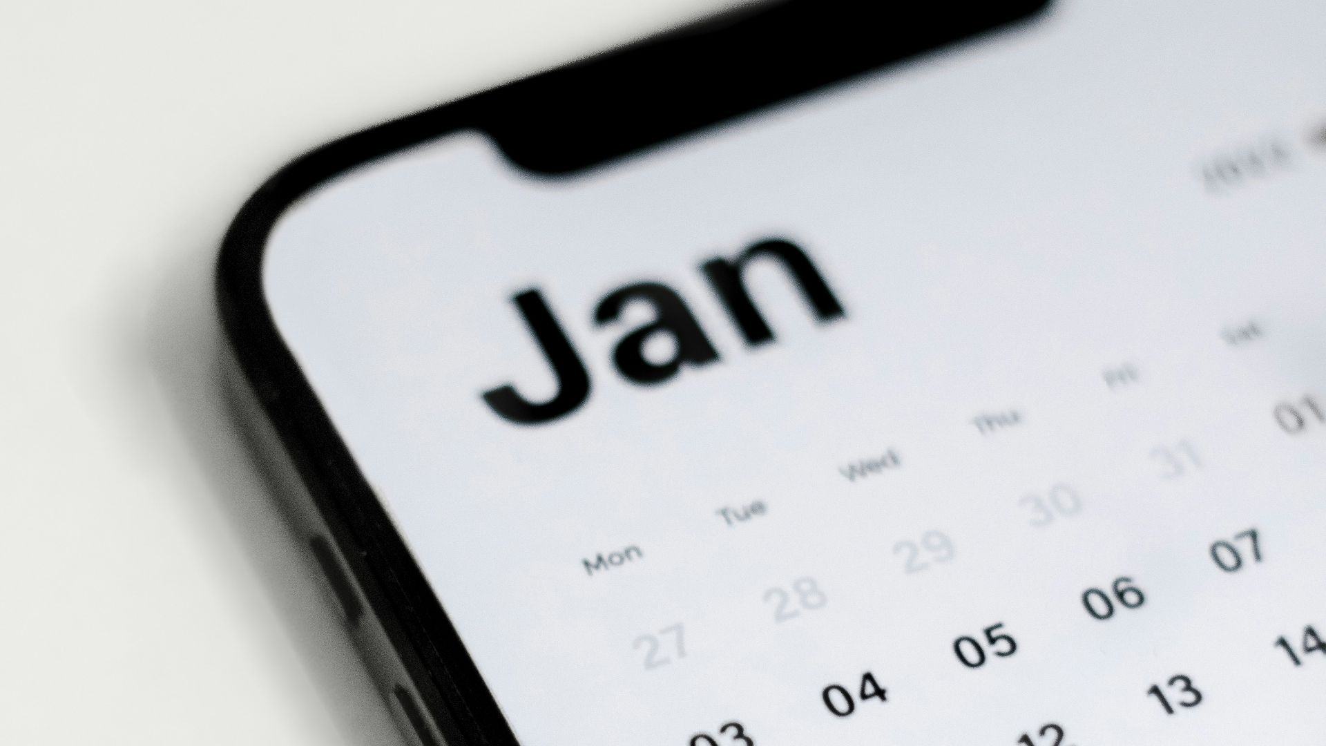 a close up of a cell phone with a calendar on it