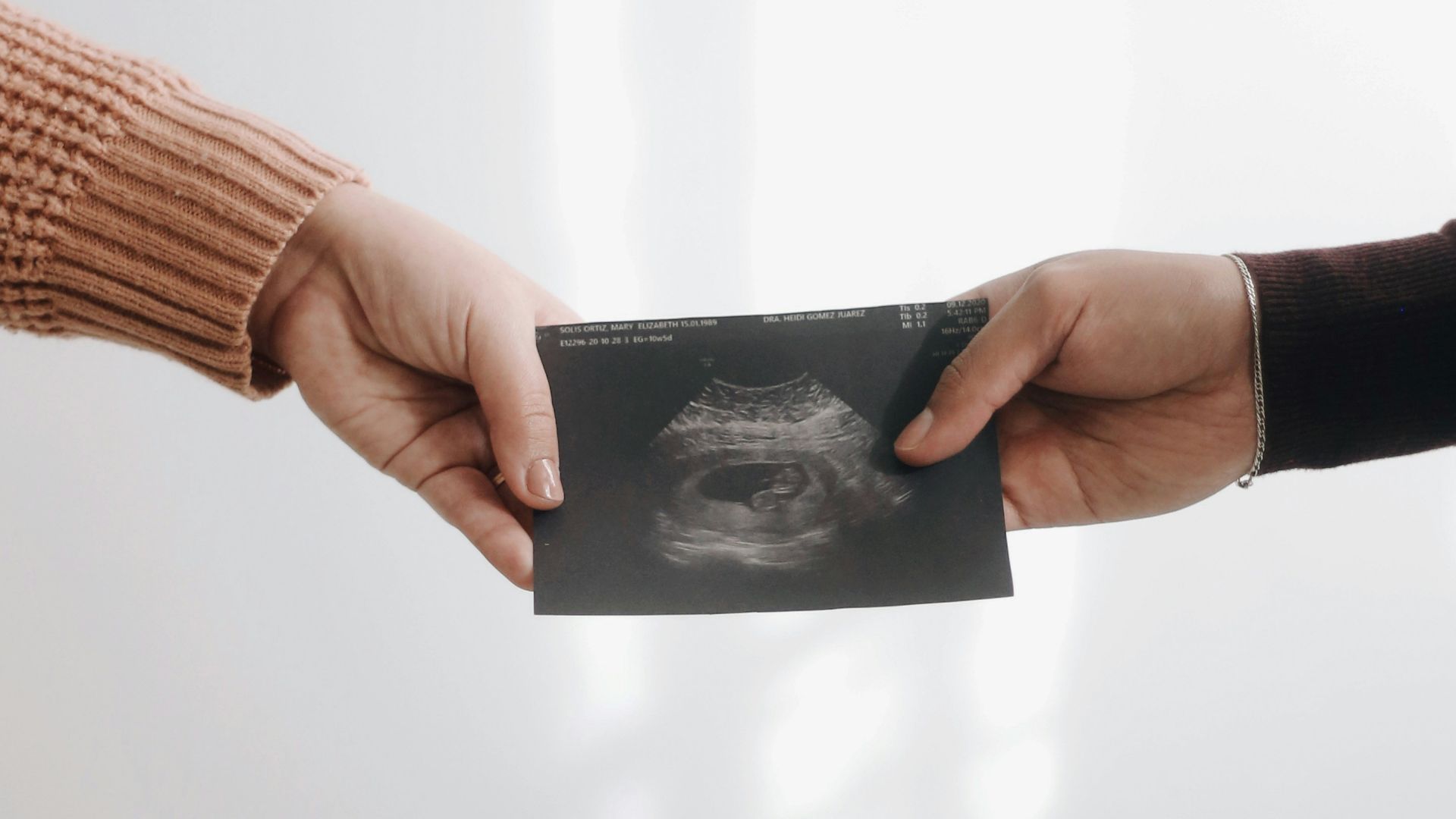 person in brown long sleeve shirt holding black book