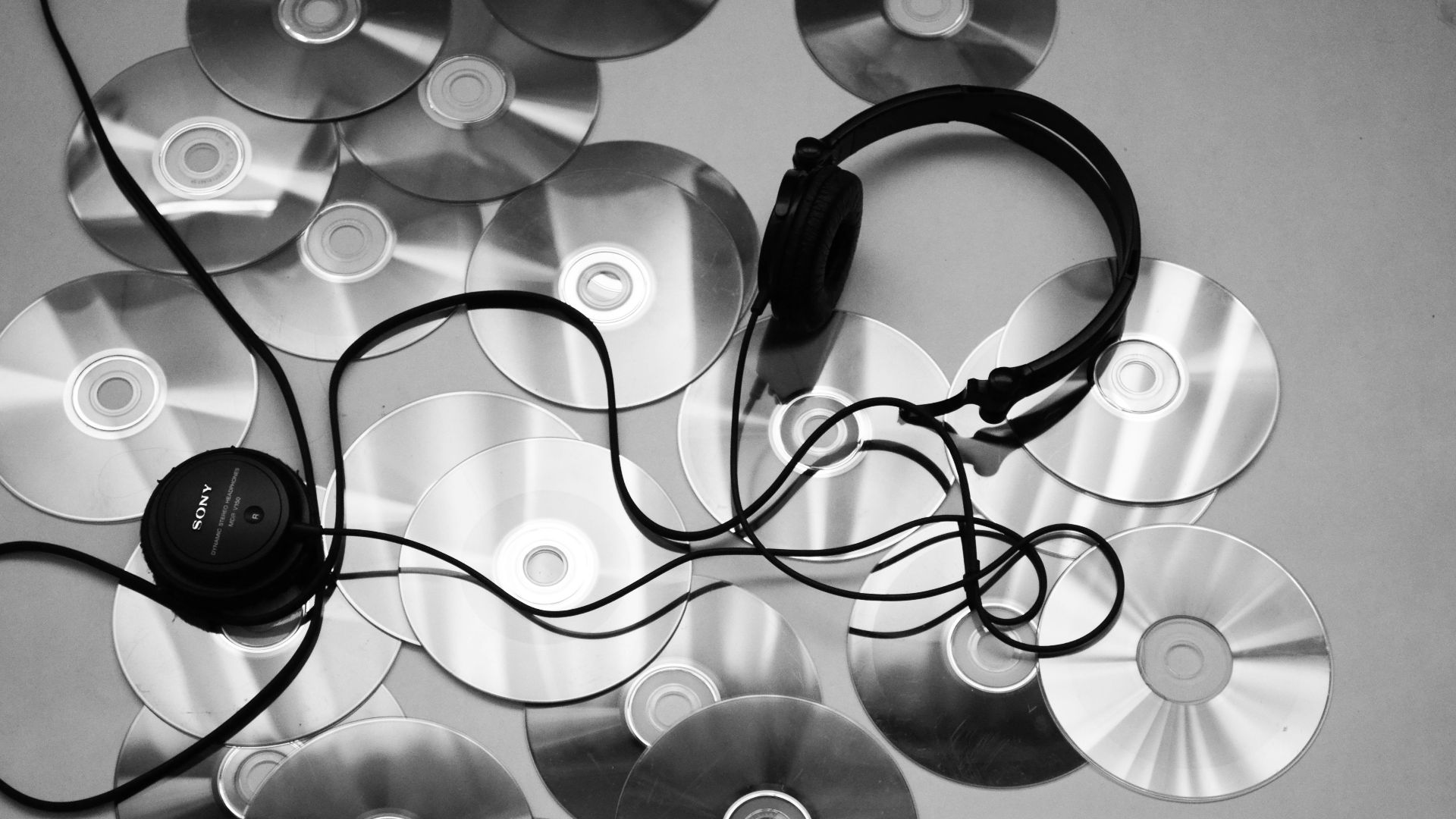 black corded headphones on white surface