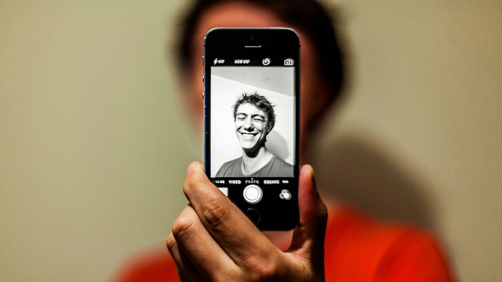 person holding space gray iPhone 5s taking picture