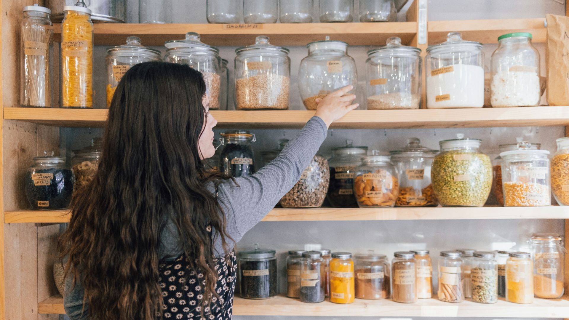 a person holding a jar of food