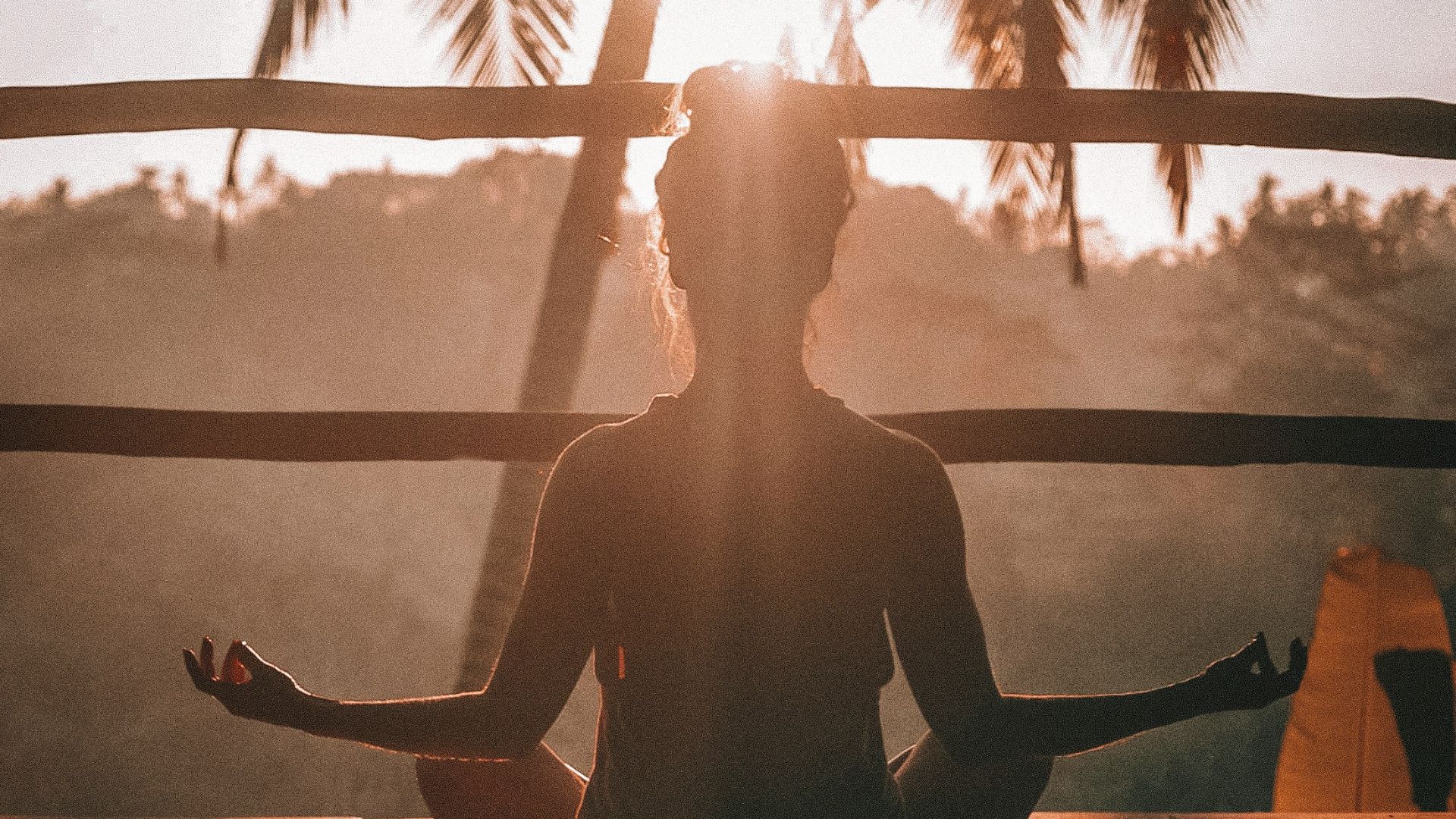 woman doing yoga meditation on brown parquet flooring