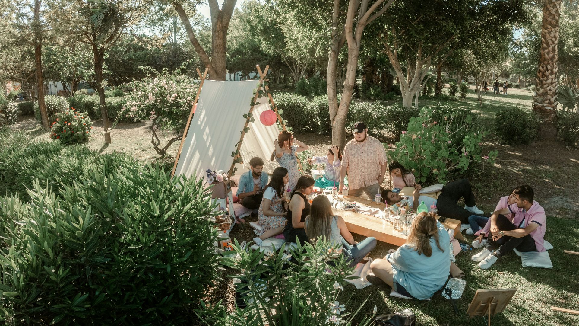 a group of people sitting around a picnic table