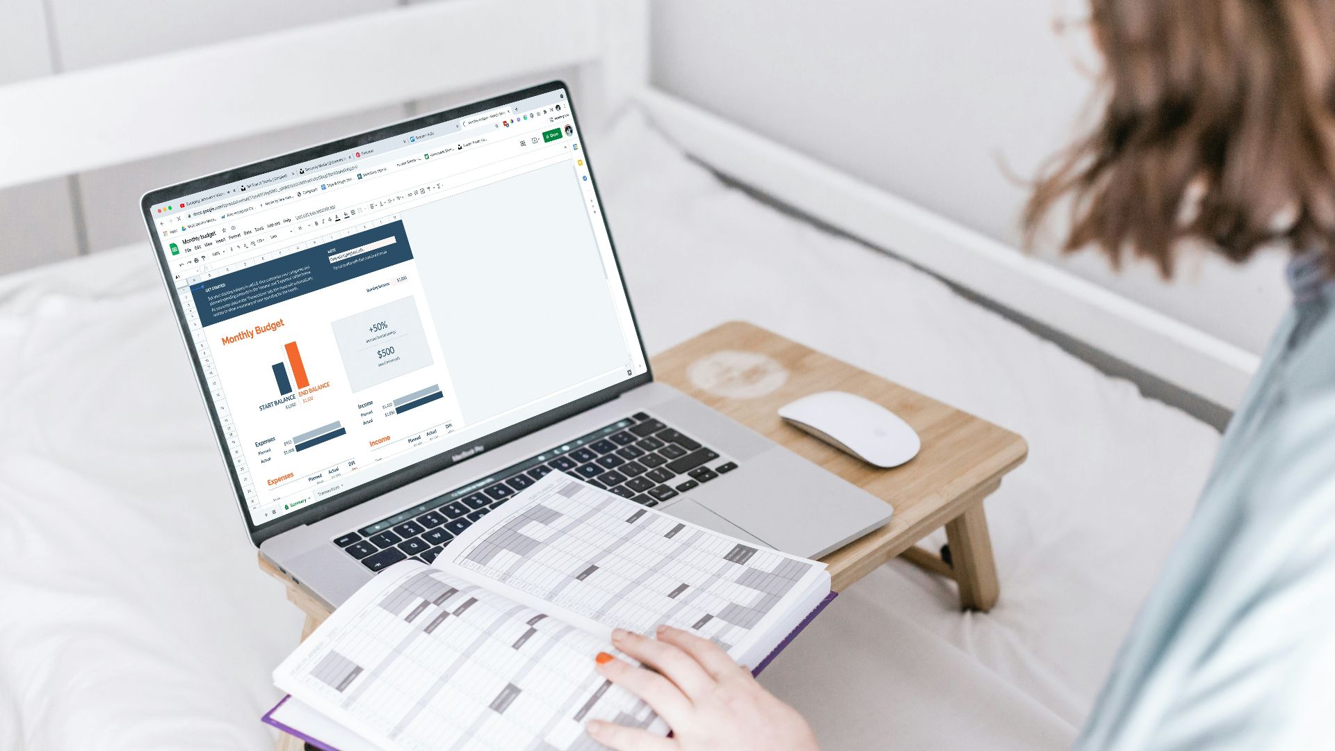 a person sitting on a bed with a laptop