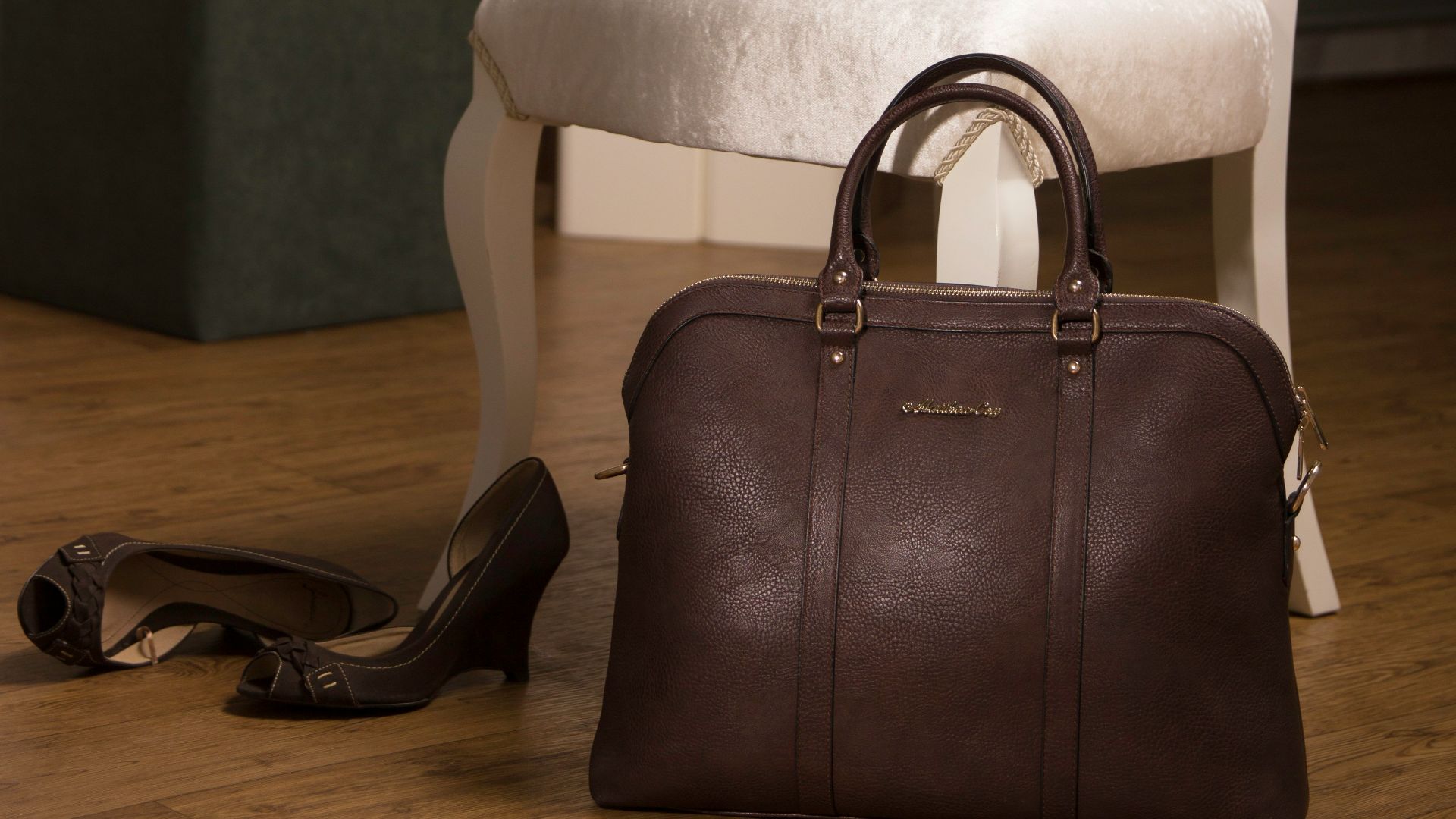 brown leather handbag near chair