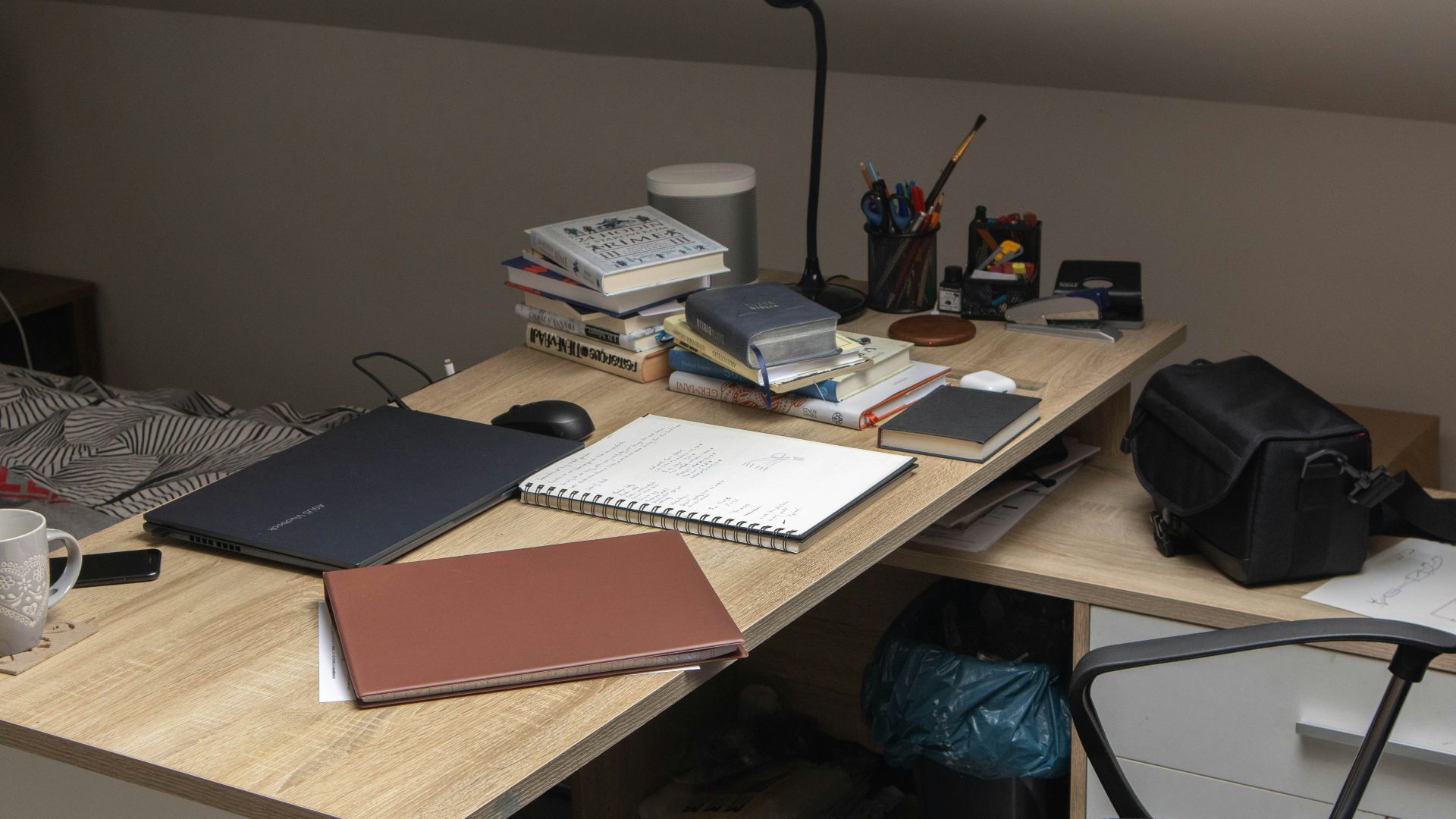 a wooden desk topped with a laptop computer