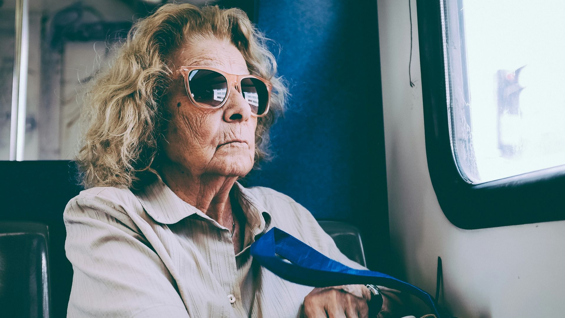 woman sitting on chair in front of window