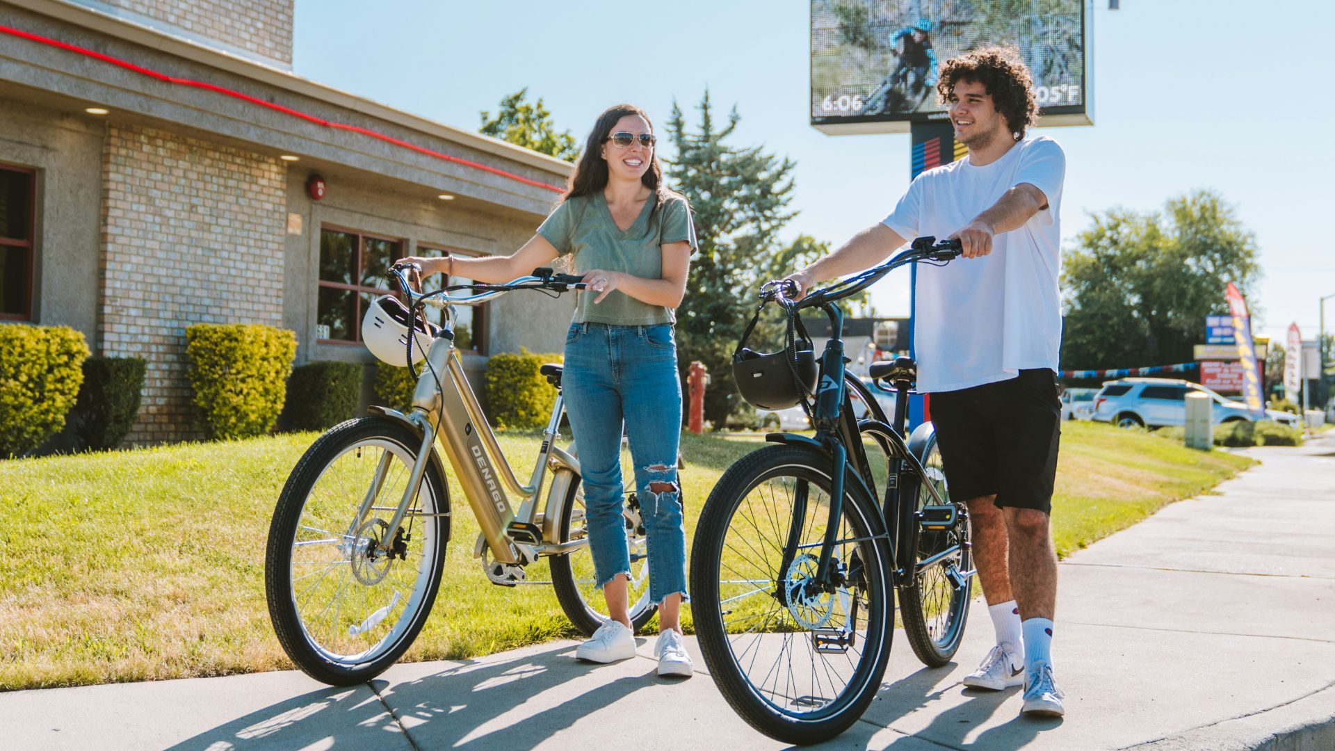 a man standing next to a woman on a bike