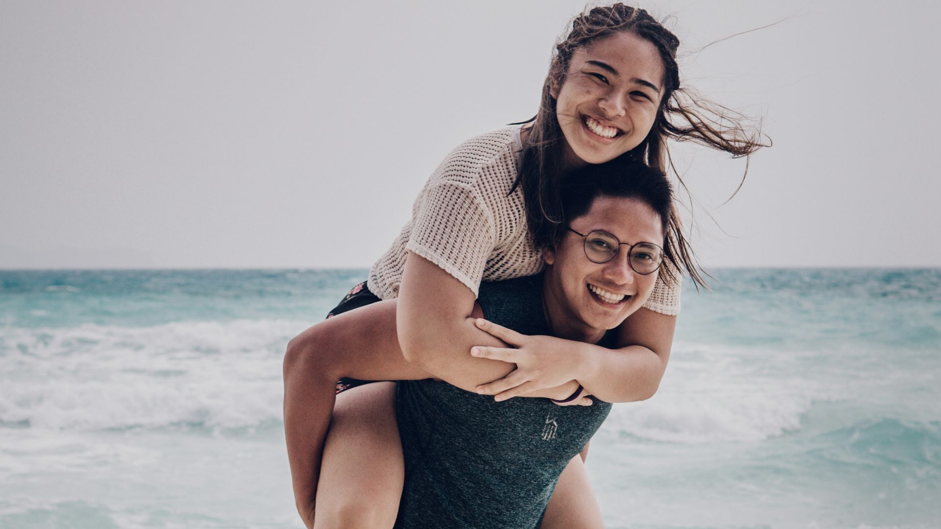 woman in blue denim shorts standing on beach during daytime