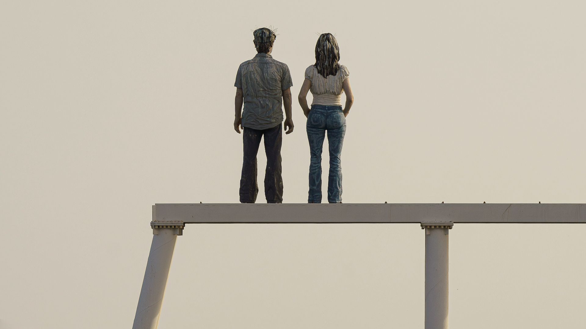 A couple stands overlooking the ocean.