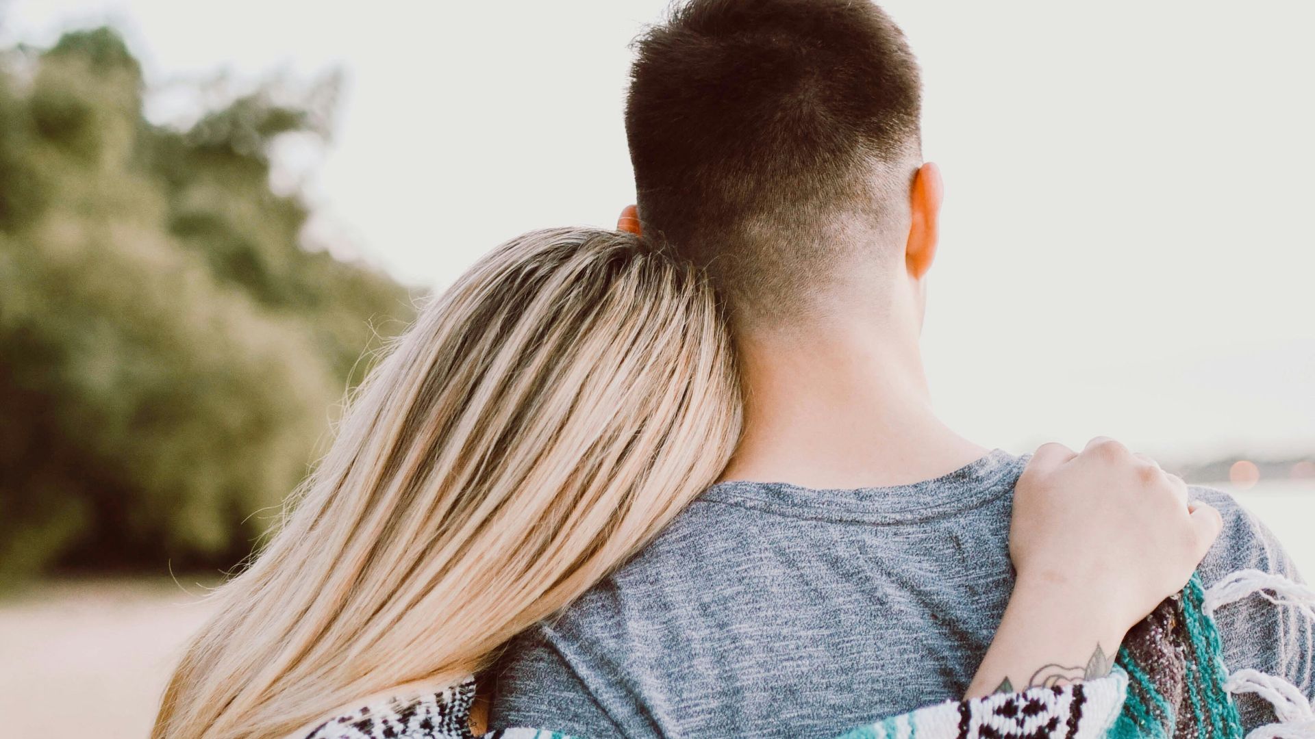 woman's hand on man's shoulder