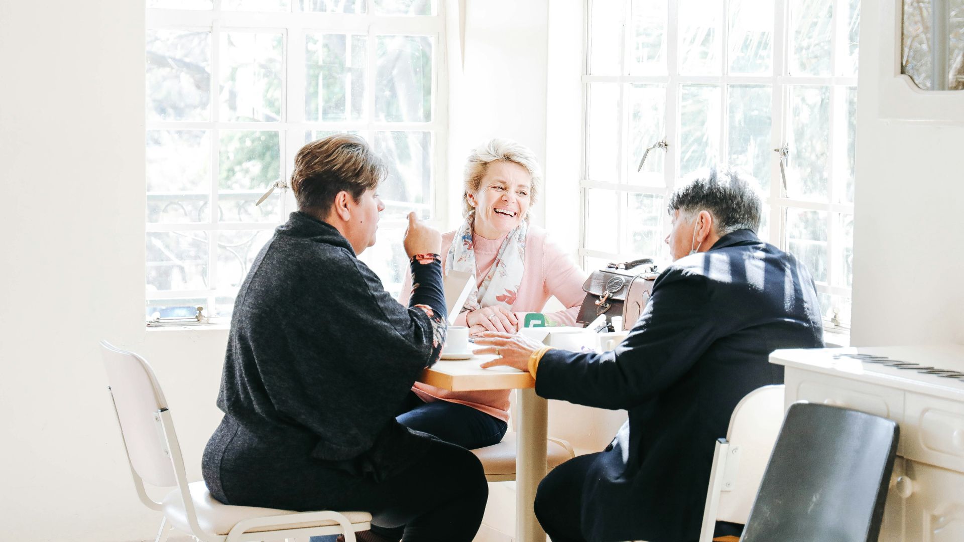 a group of people sitting around a table