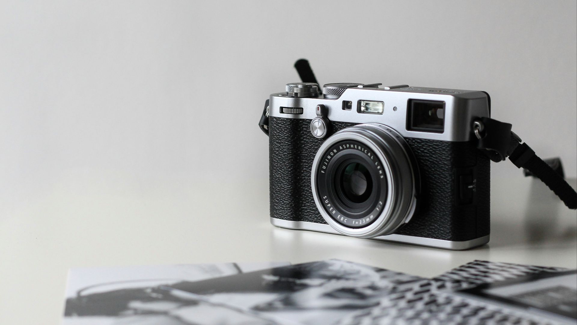 black and gray film camera near printed photos