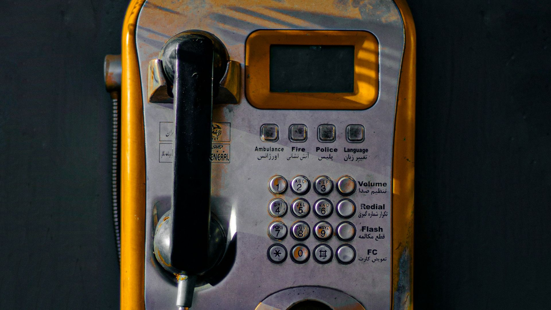 An old style telephone with a cord attached to it