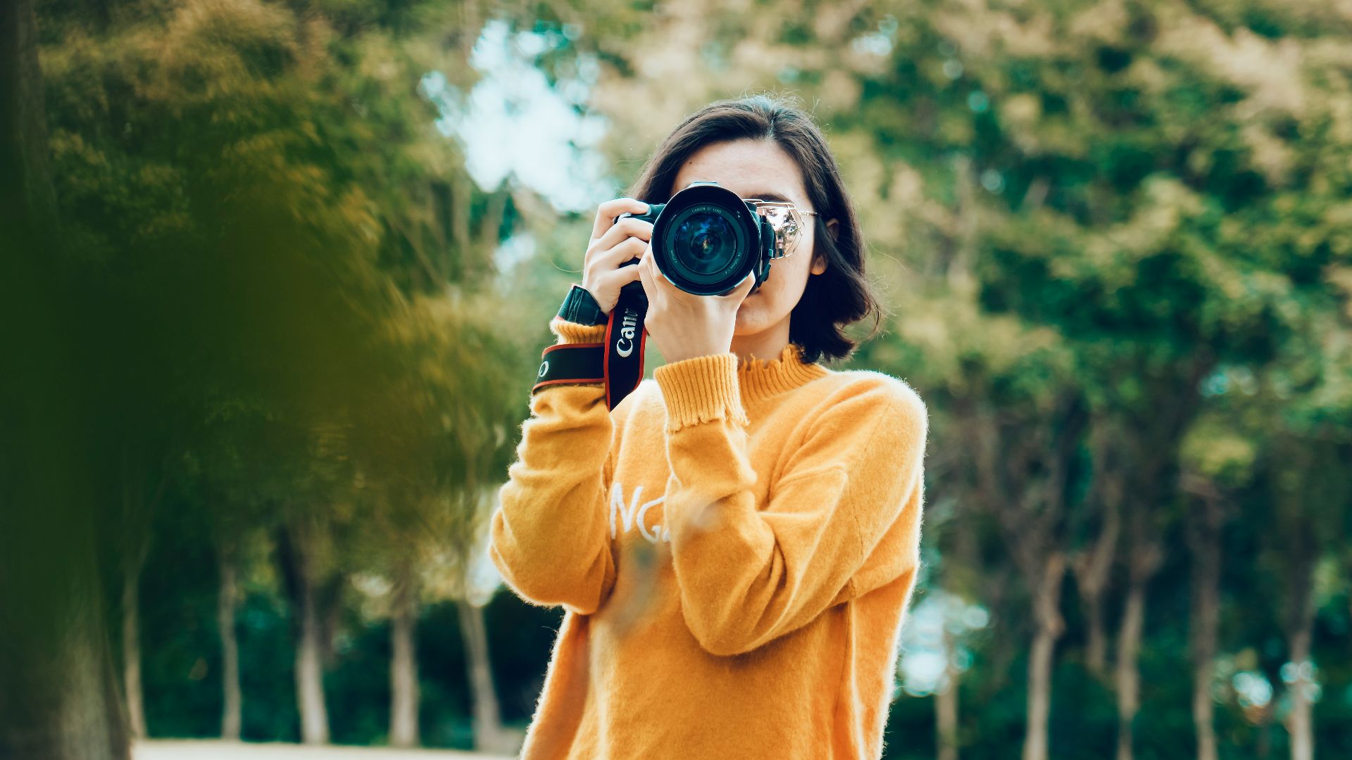 woman holding DSLR camera