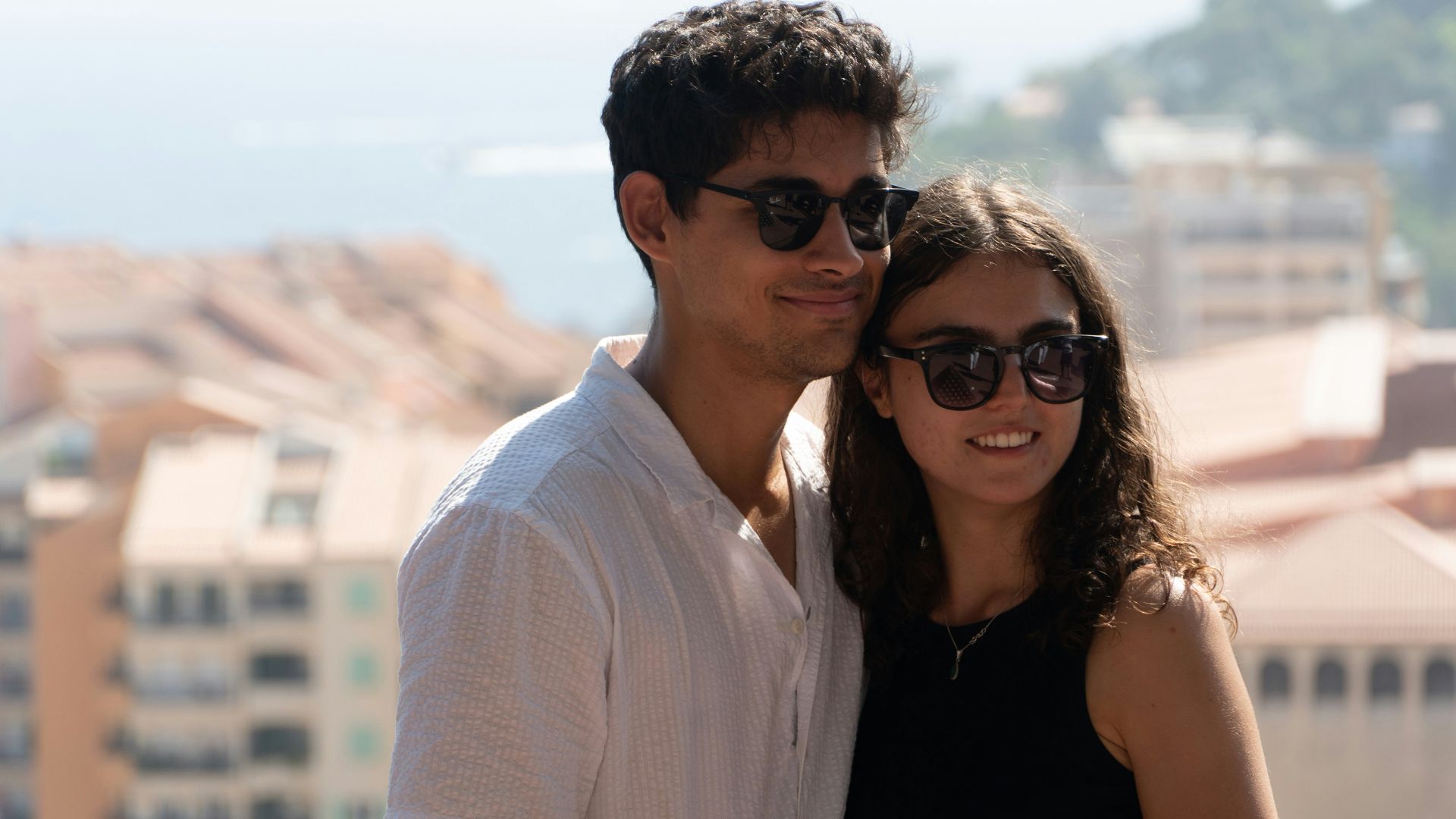 Young couple posing with buildings in background