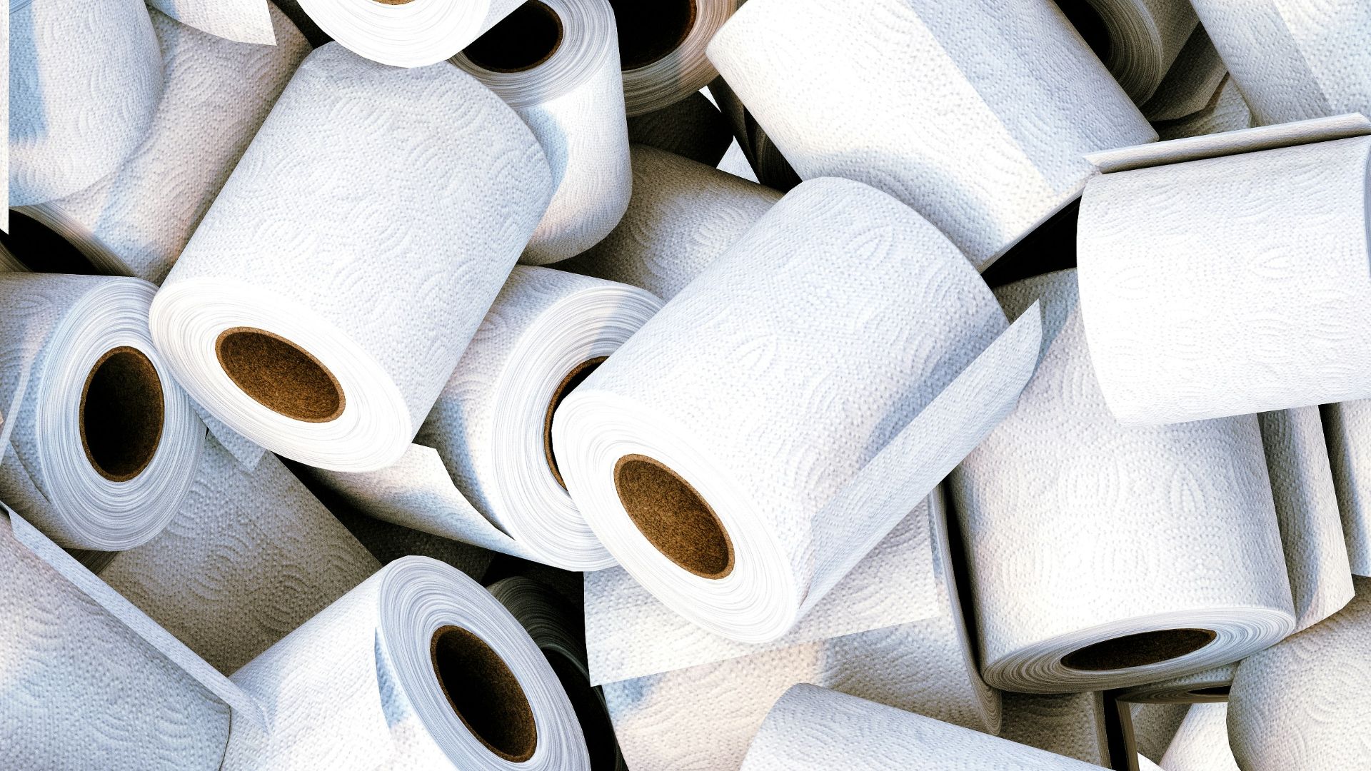 a pile of white toilet paper sitting next to each other