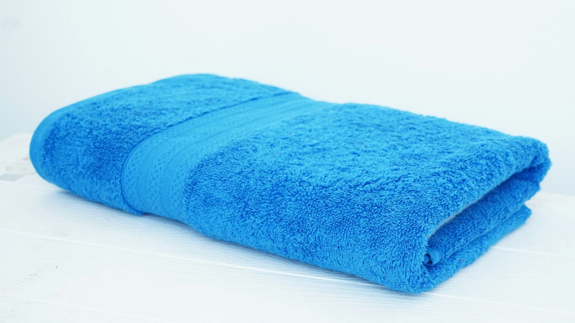 a blue towel sitting on top of a white table