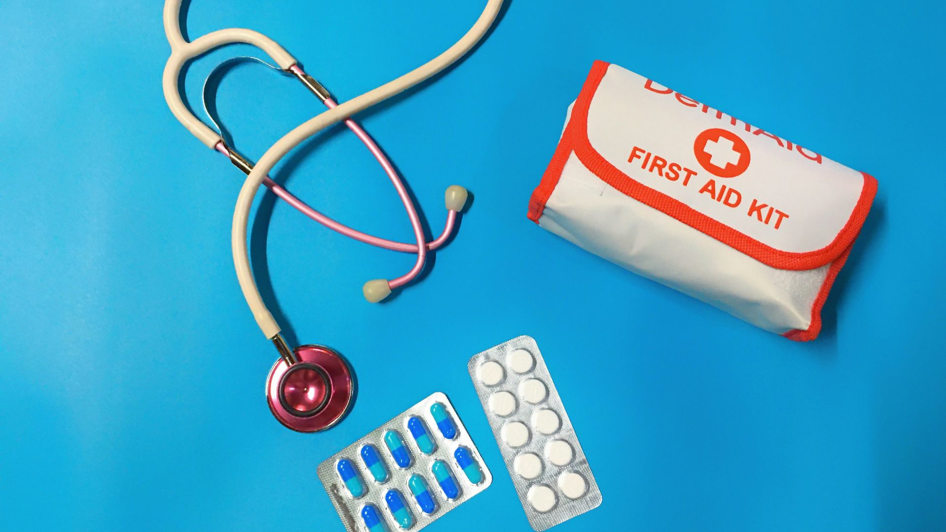 a bag of pills, a stethoscope, and a first aid kit