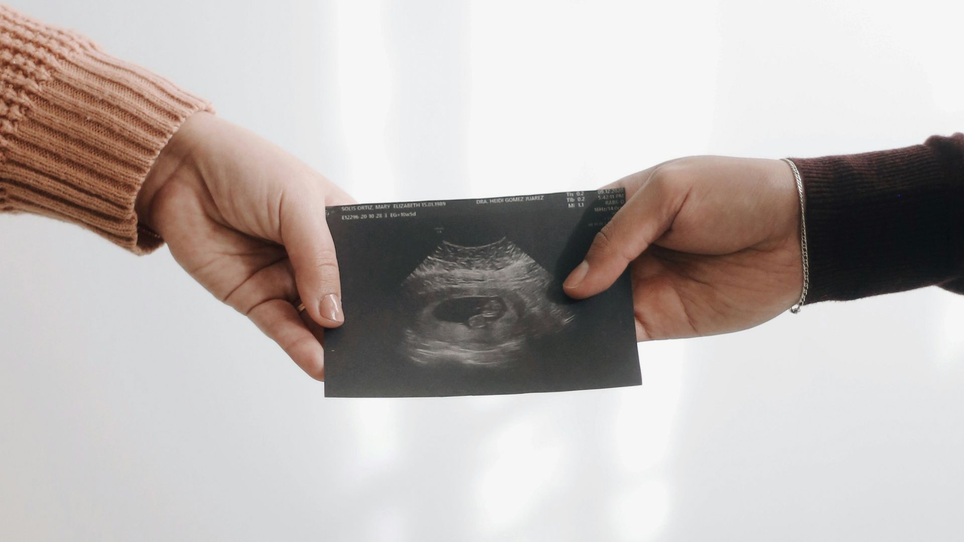 person in brown long sleeve shirt holding black book