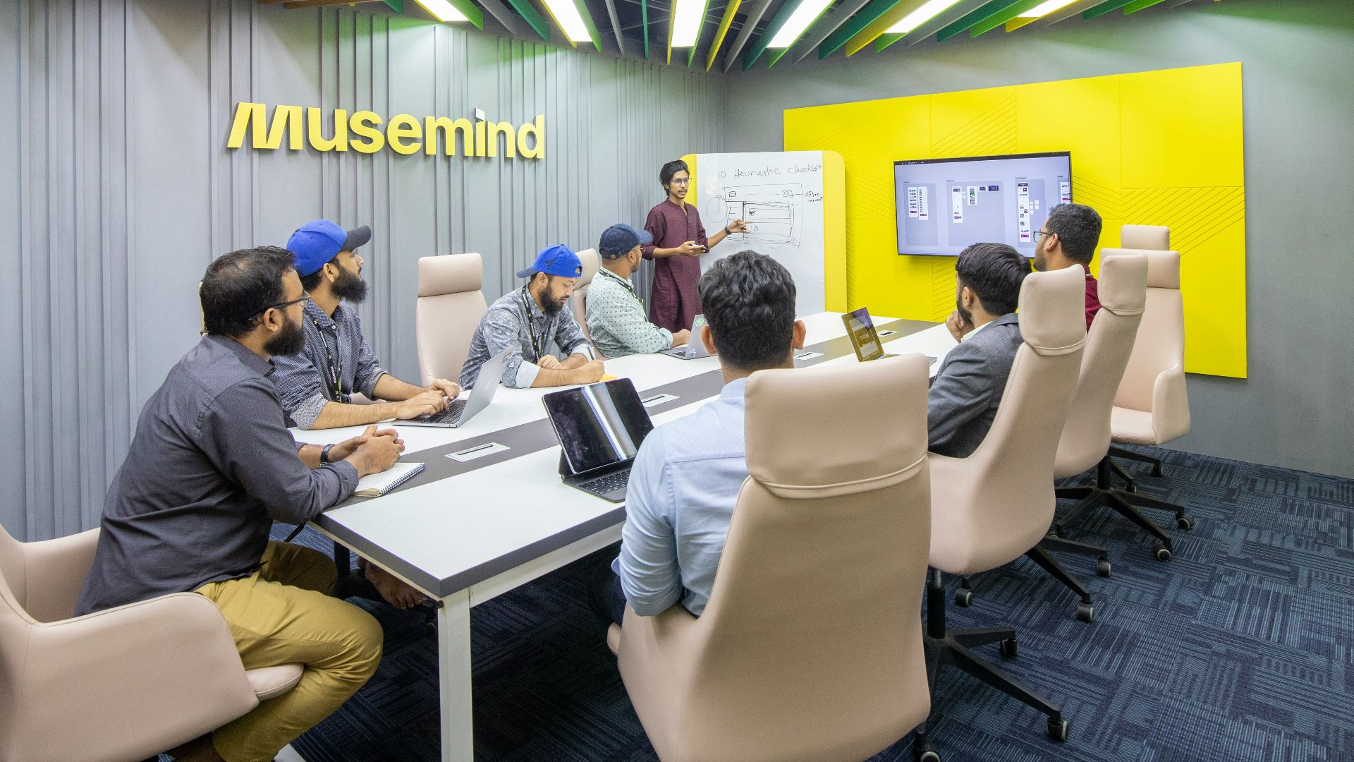 a group of people sitting around a conference table