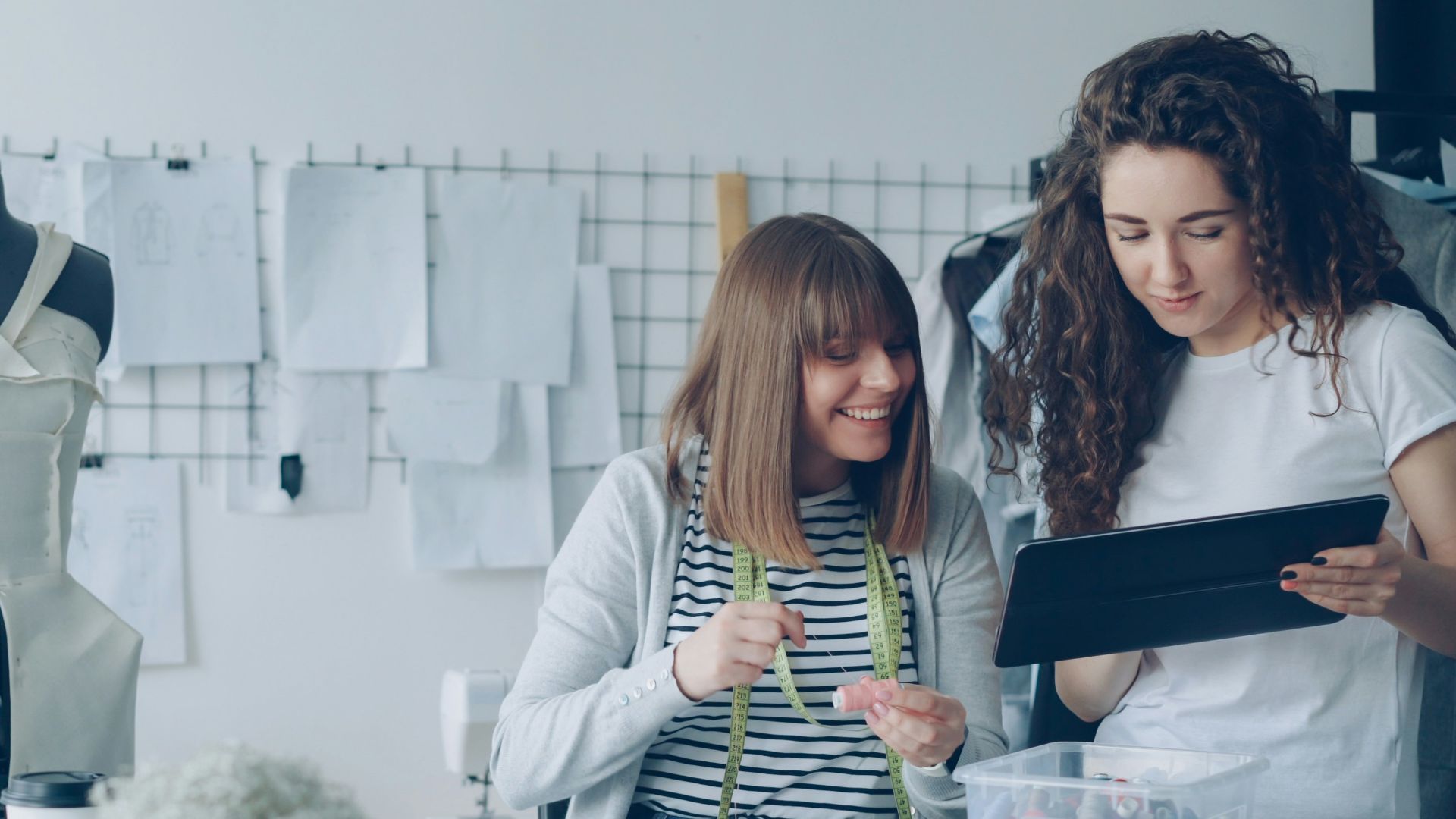 Two designers collaborate in a fashion studio.