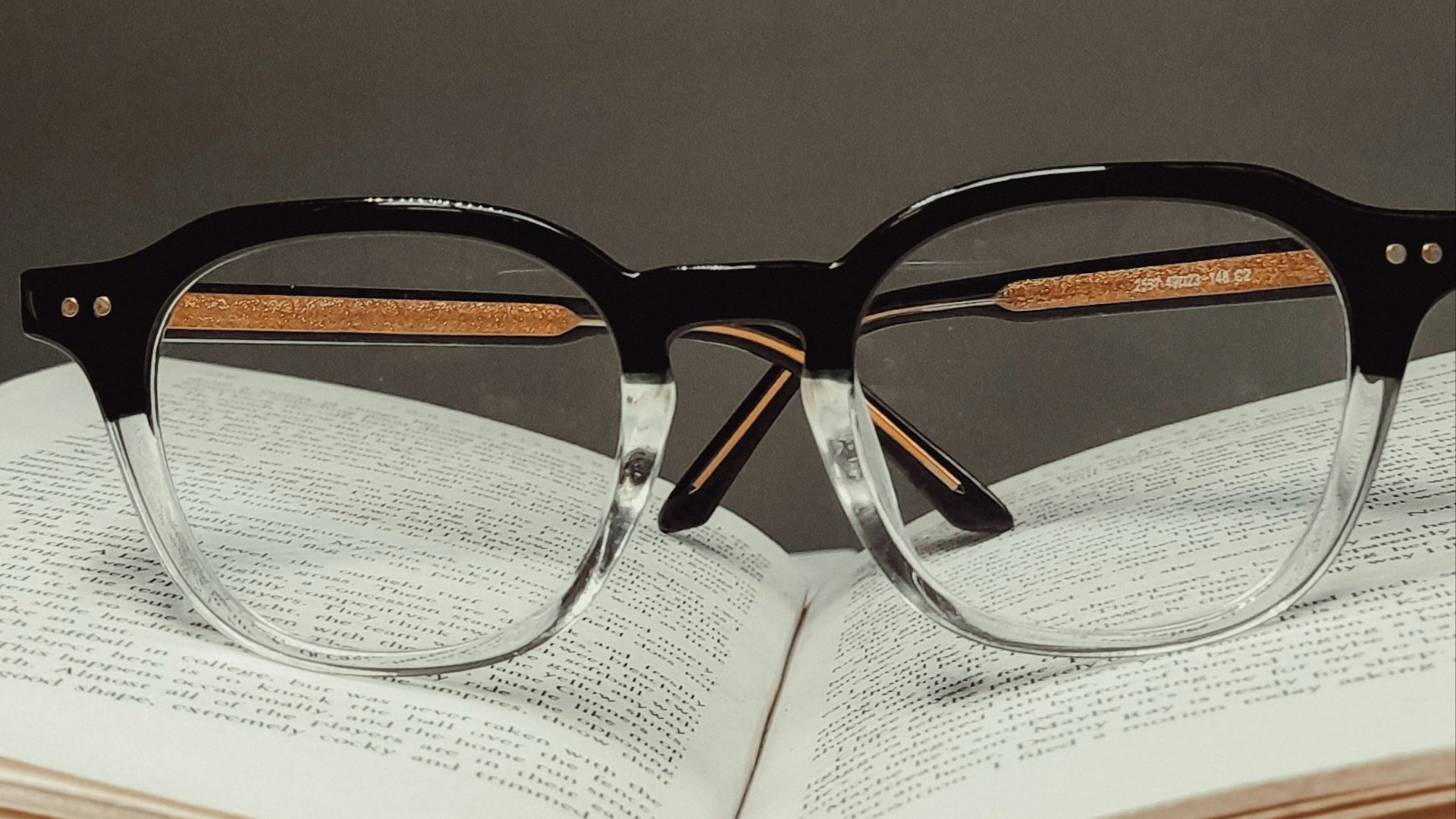 black framed eyeglasses on book page