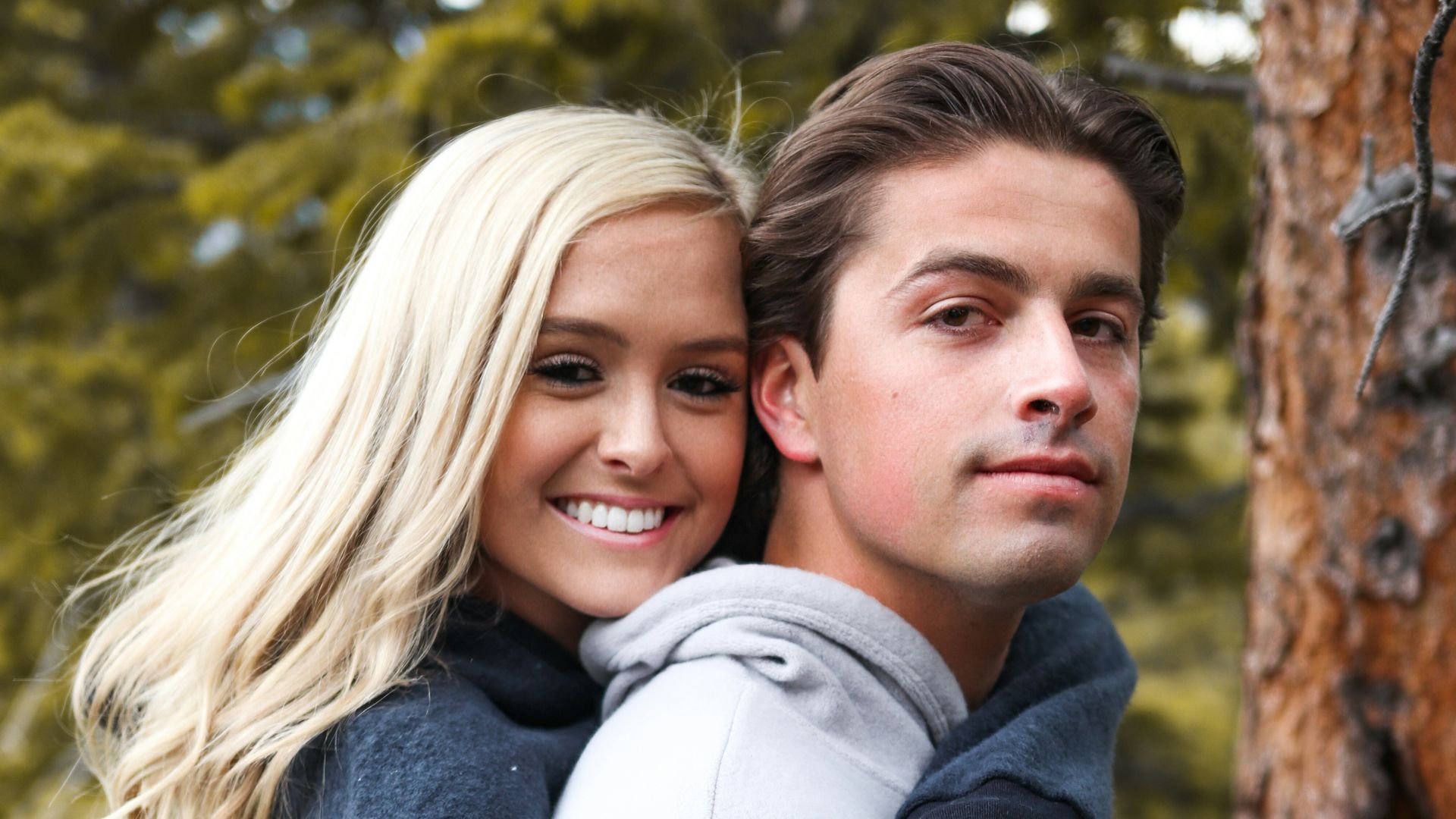 woman in gray long sleeve shirt hugging girl in black jacket