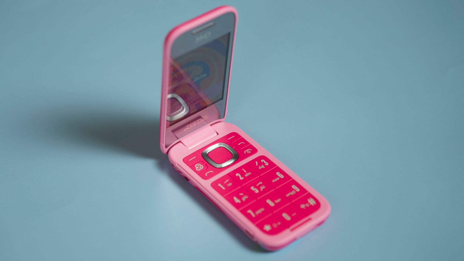A pink cell phone sitting in a pink case