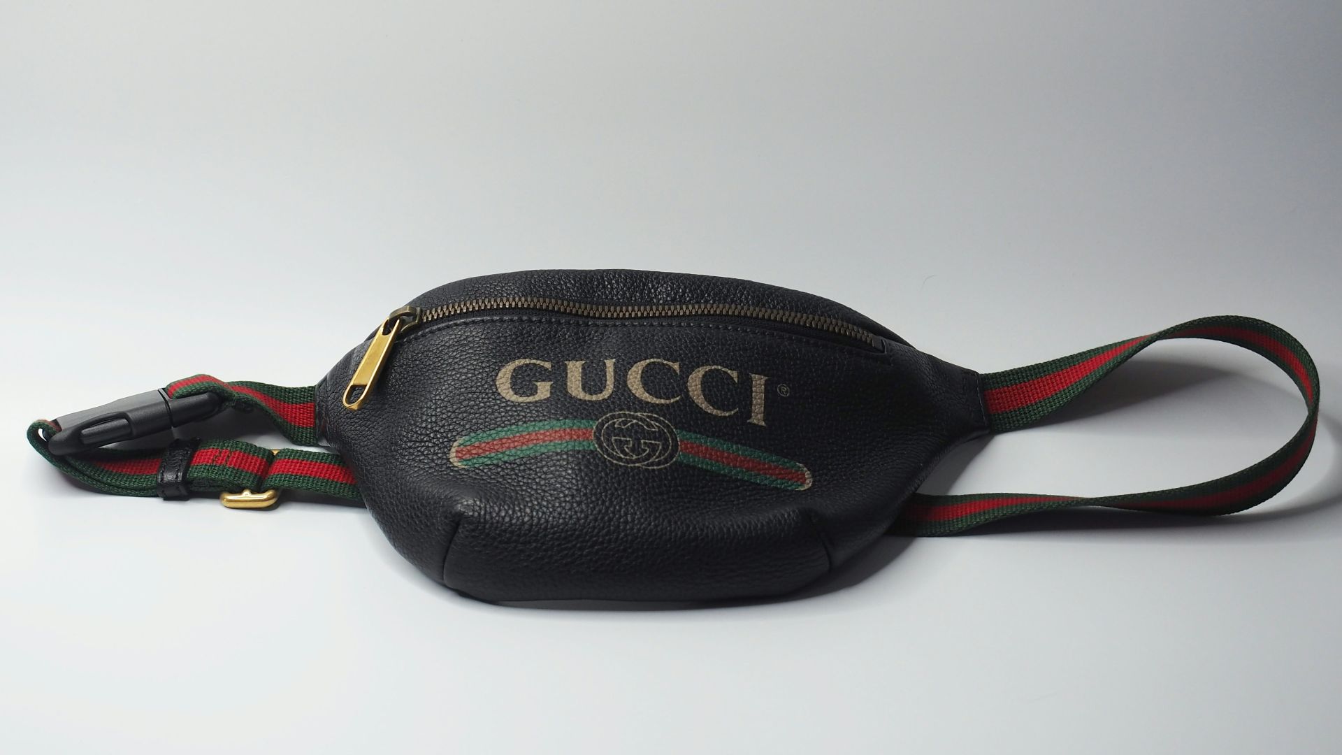a gucci belt bag on a white background