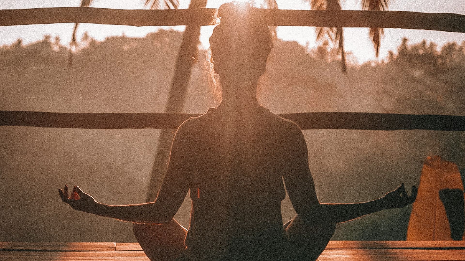 woman doing yoga meditation on brown parquet flooring