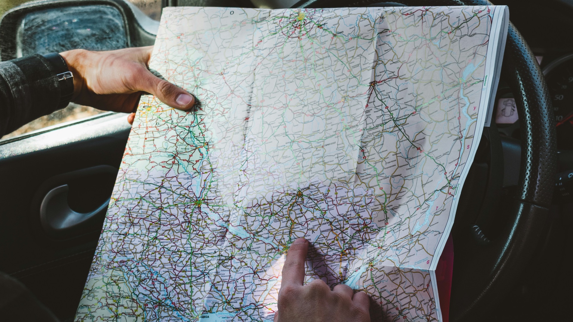 person holding map in vehicle\