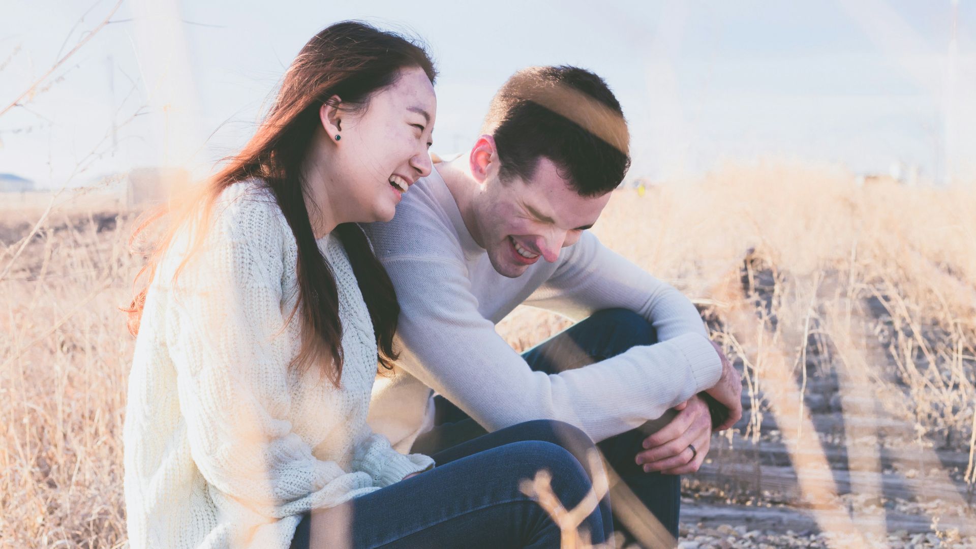 photo of man and woman laughing during daytime