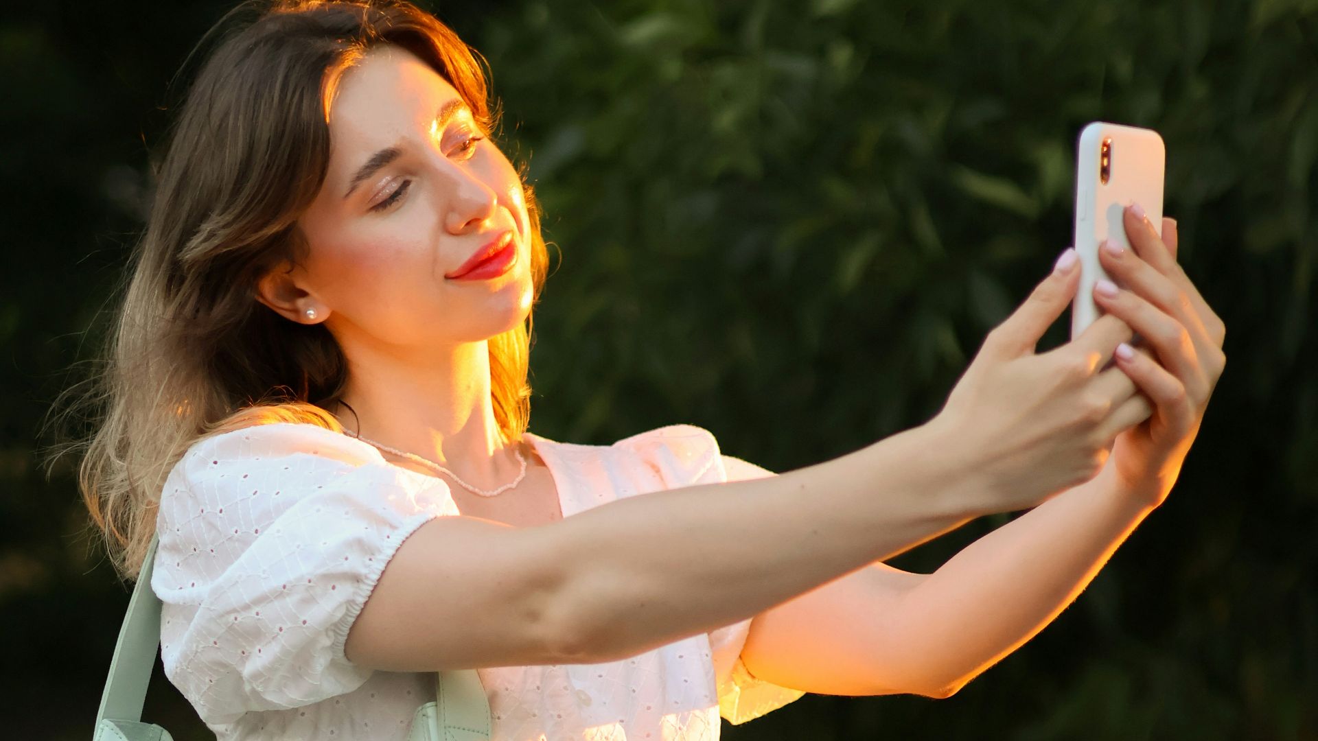 a woman taking a picture with her cell phone