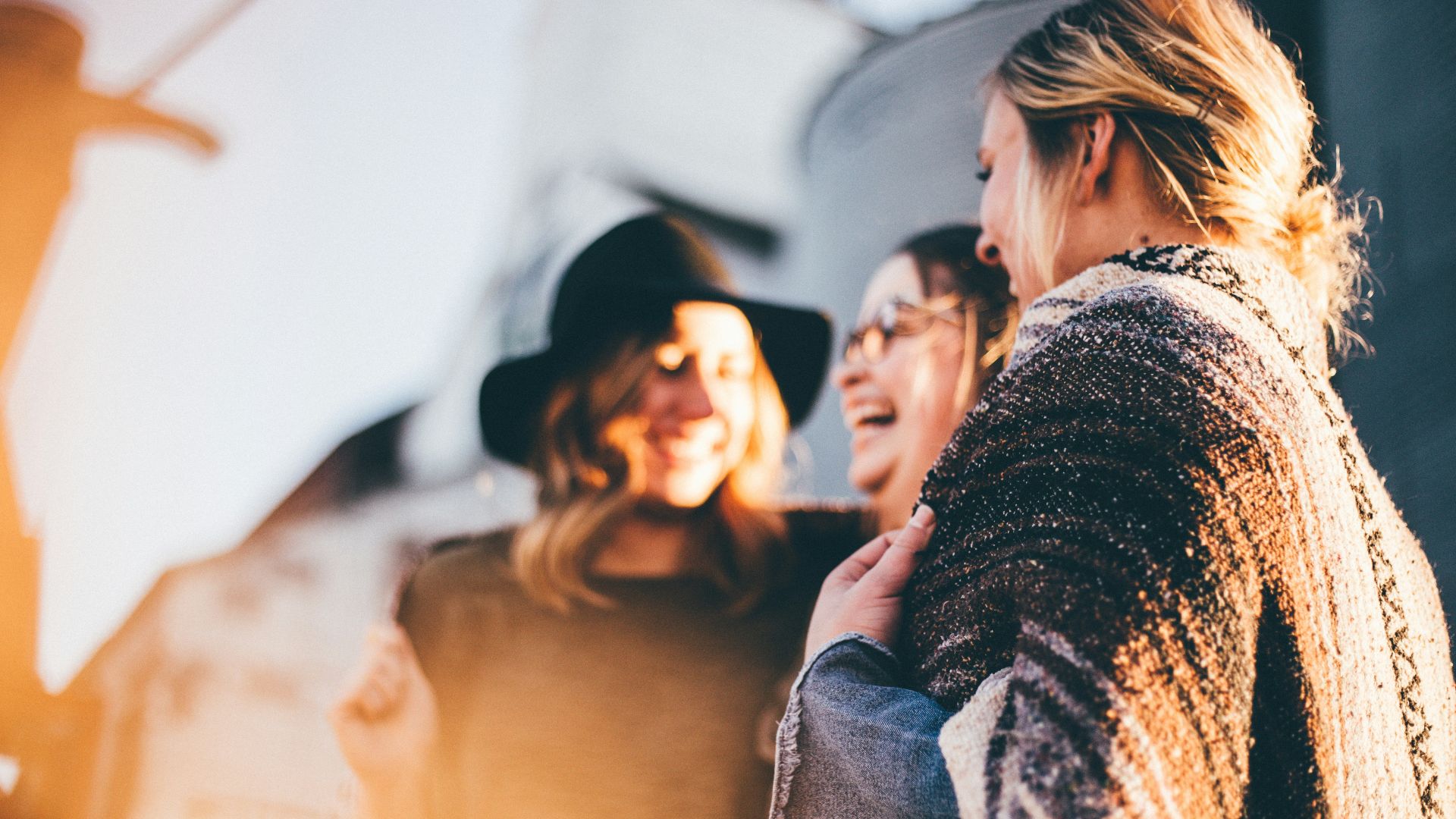 people laughing and talking outside during daytime