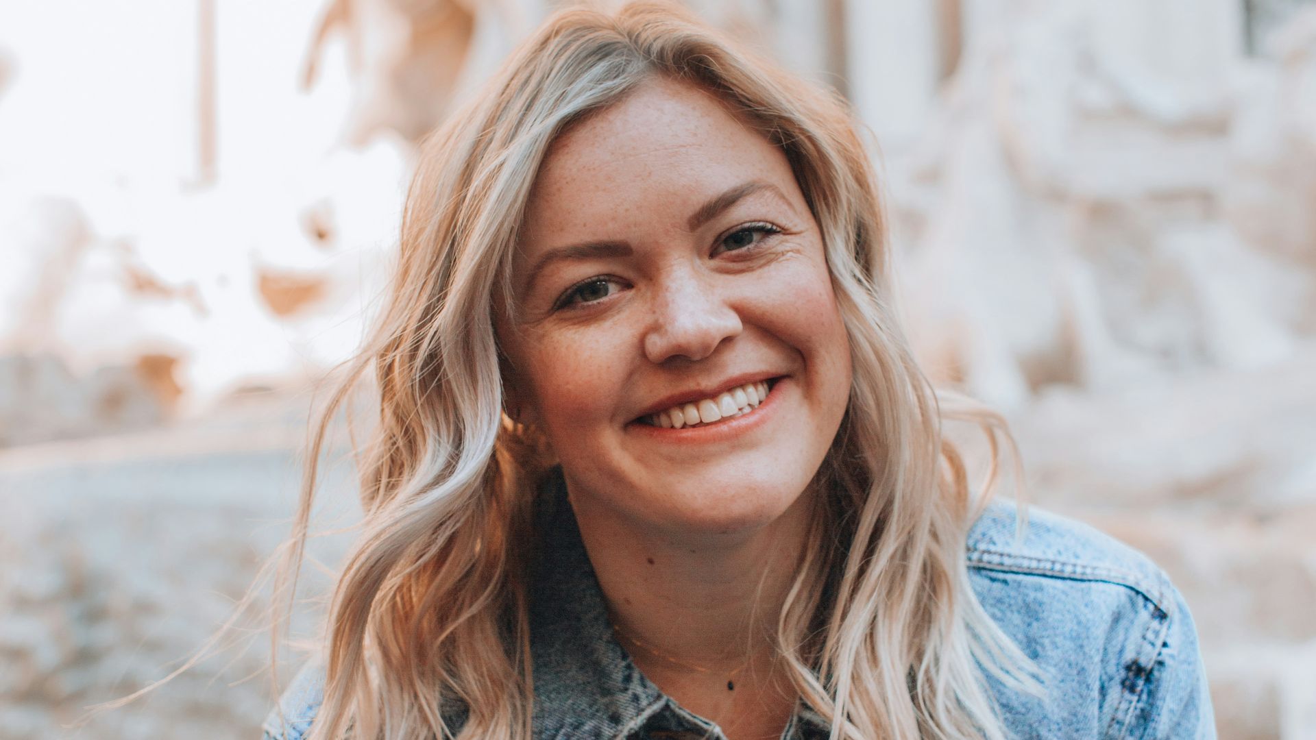 woman smiling wearing denim jacket