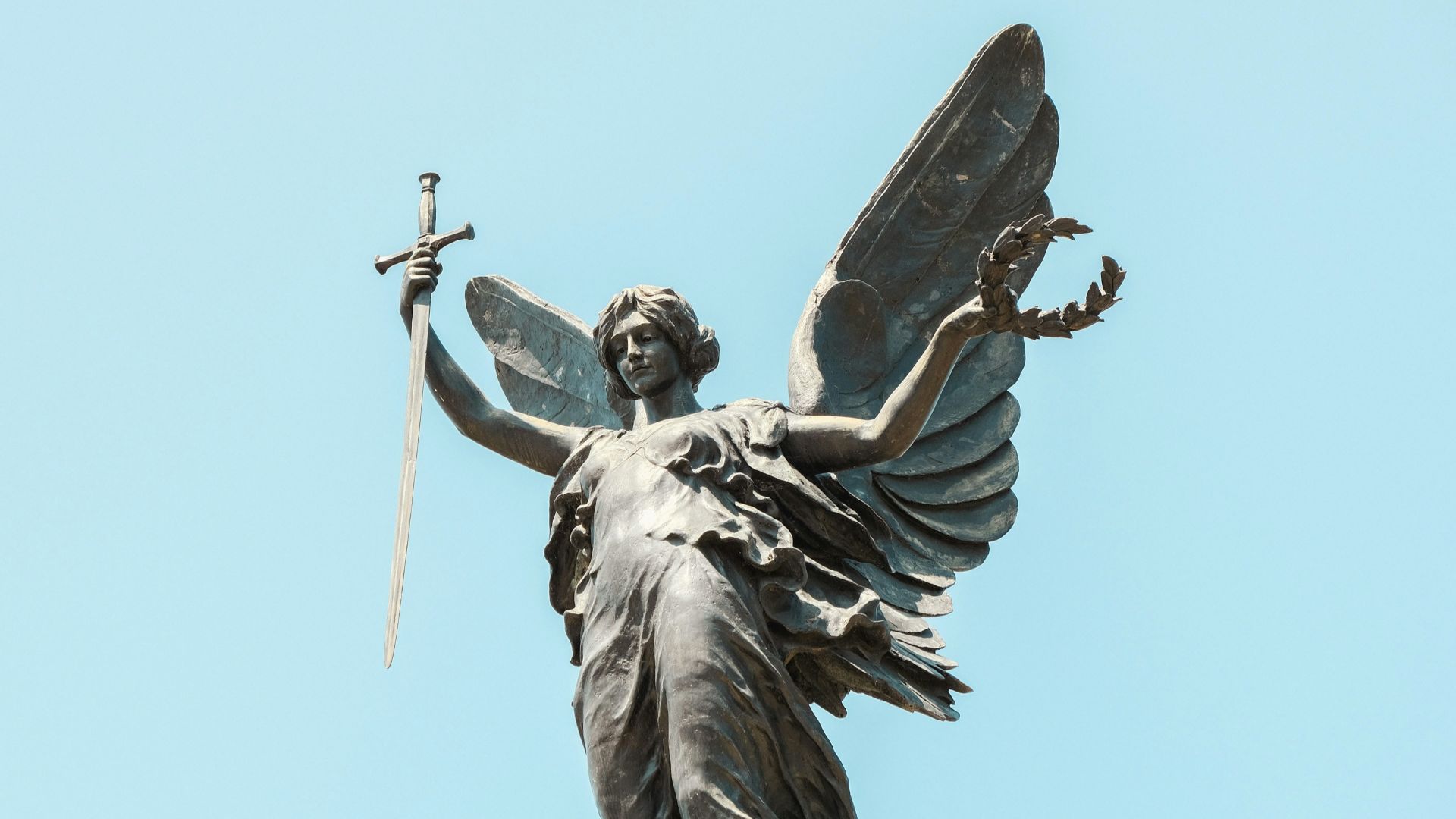 a statue of an angel holding a sword