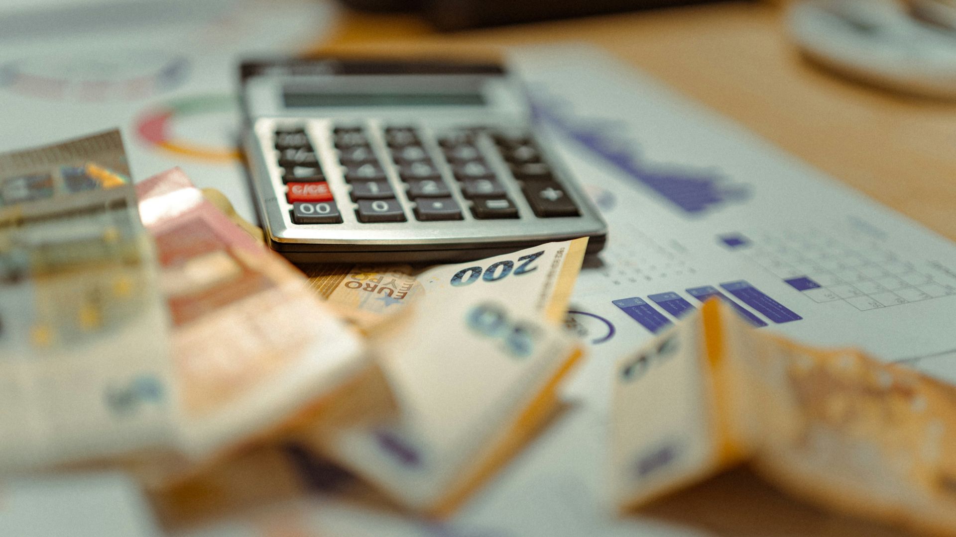 A calculator sitting on top of a pile of money