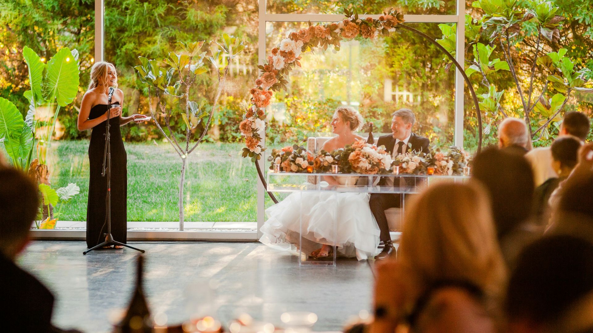 a woman standing at a podium in front of a crowd