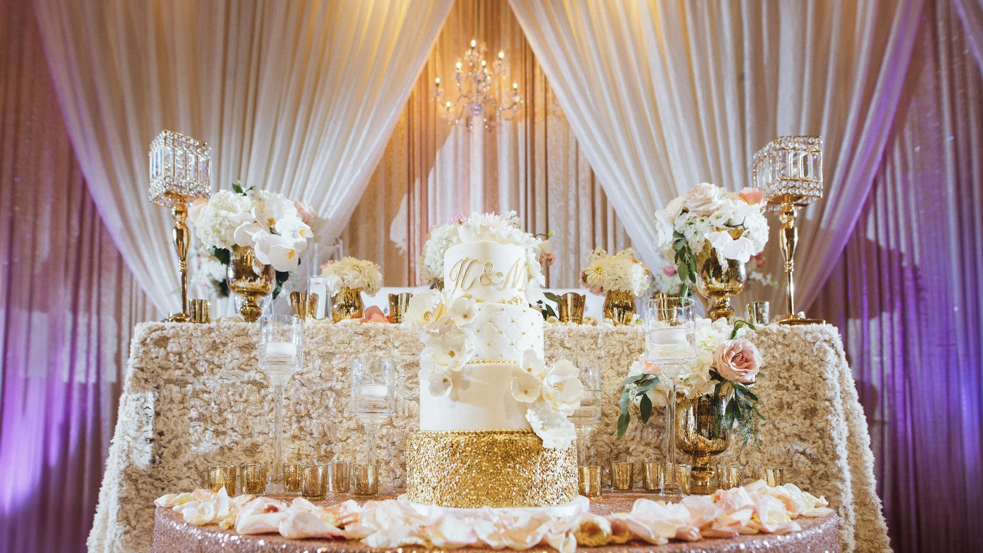 Elegant wedding cake display with floral arrangements