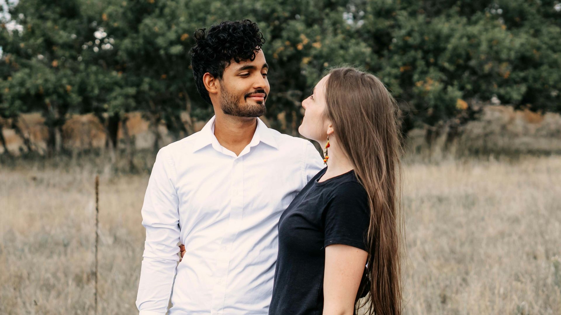A man and a woman standing in a field