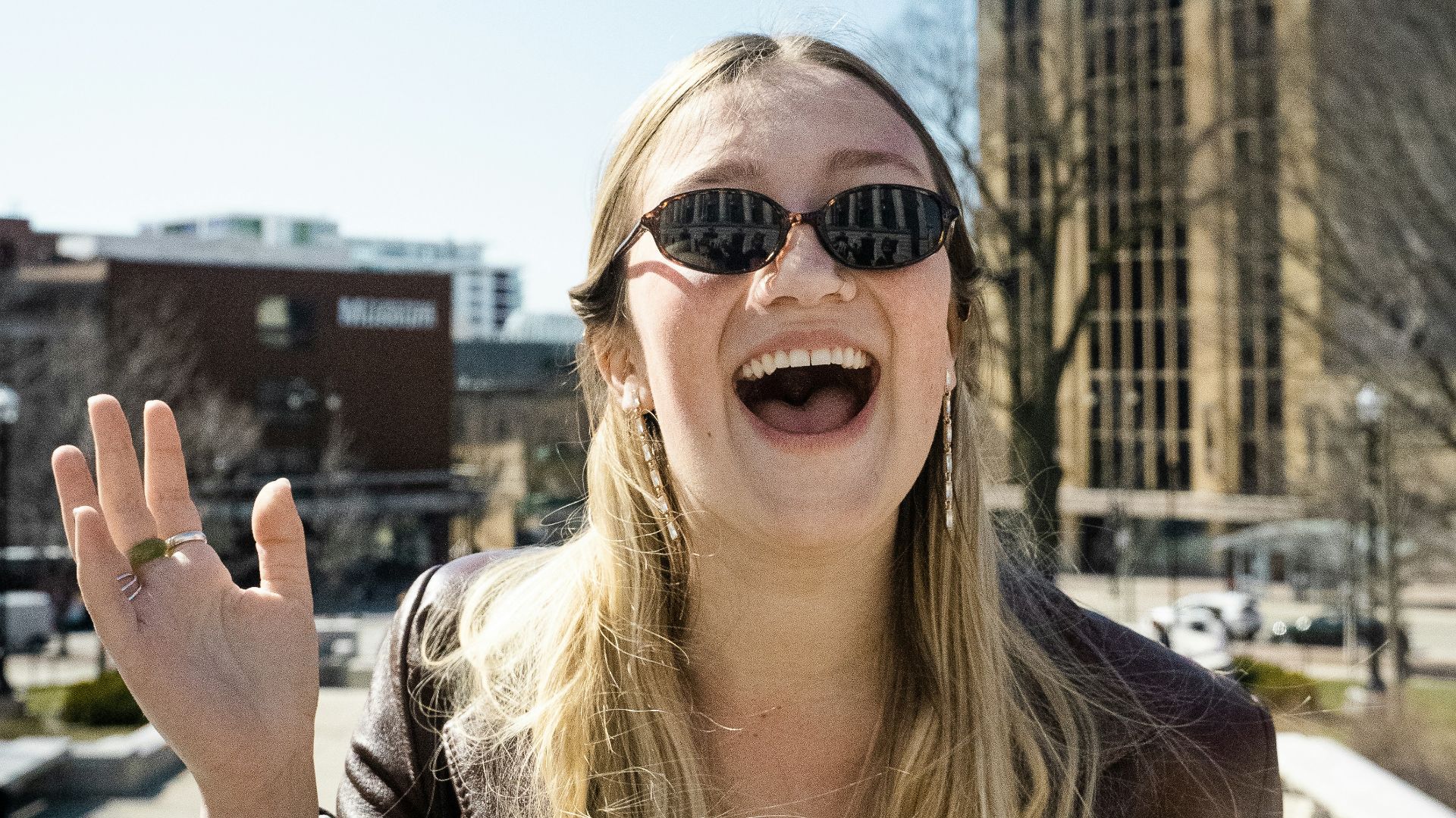 woman in brown sunglasses and brown shirt