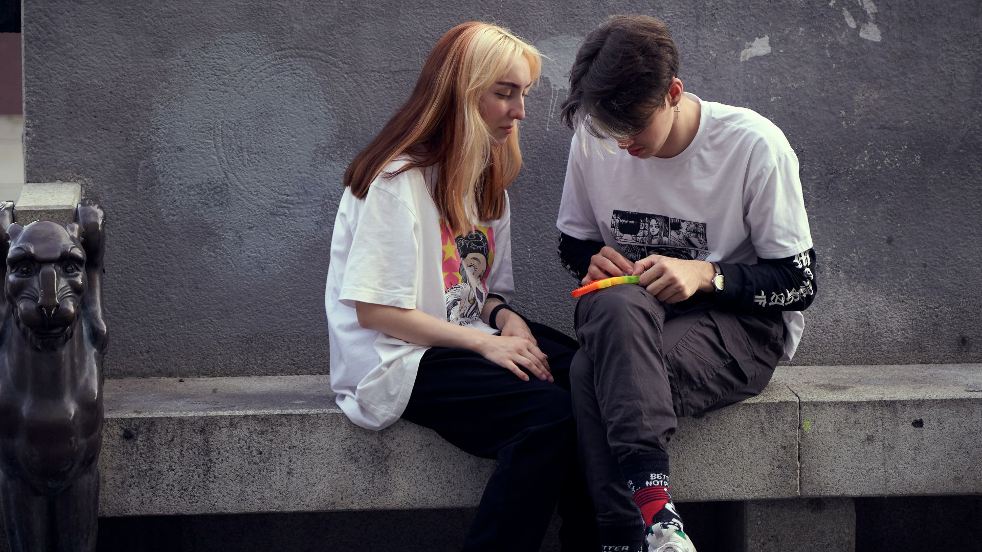 man in white crew neck t-shirt sitting beside woman in white crew neck t-shirt