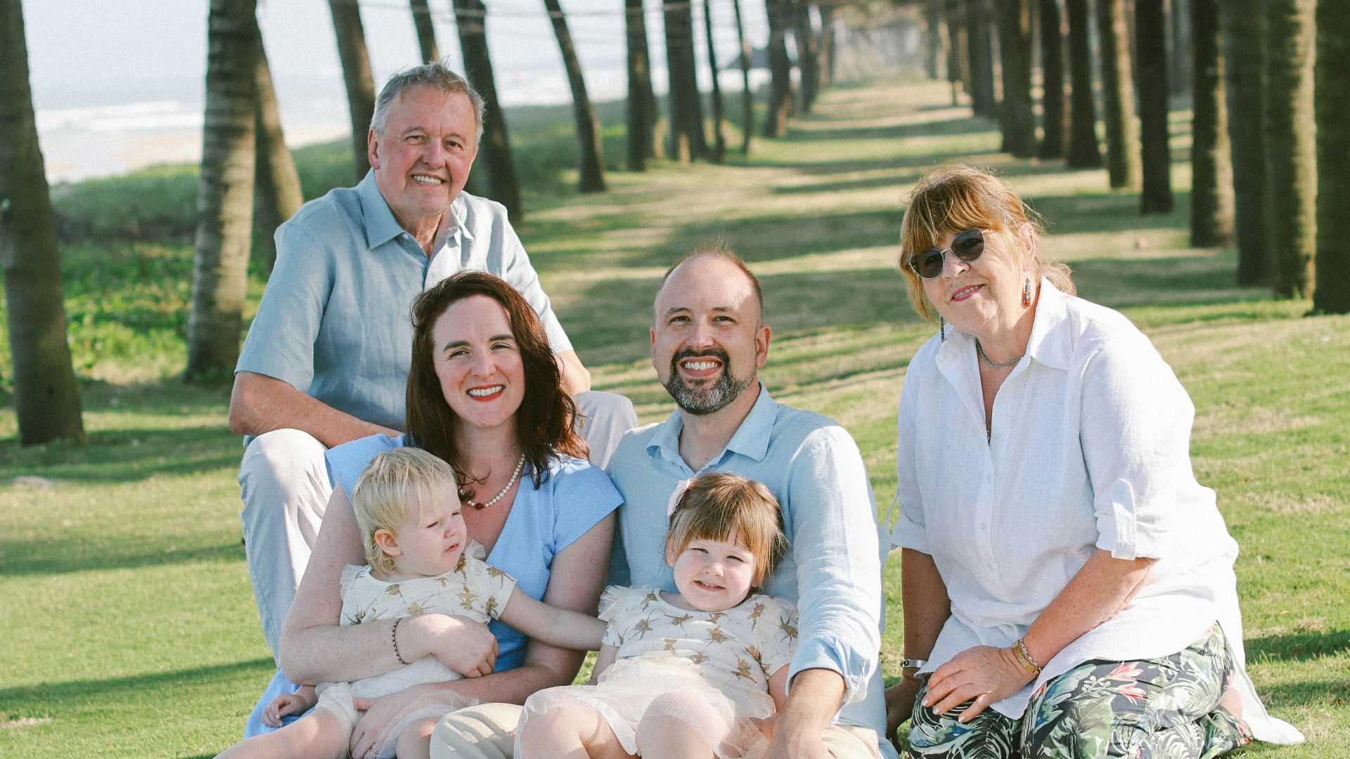 Family posing for a photo on the grass
