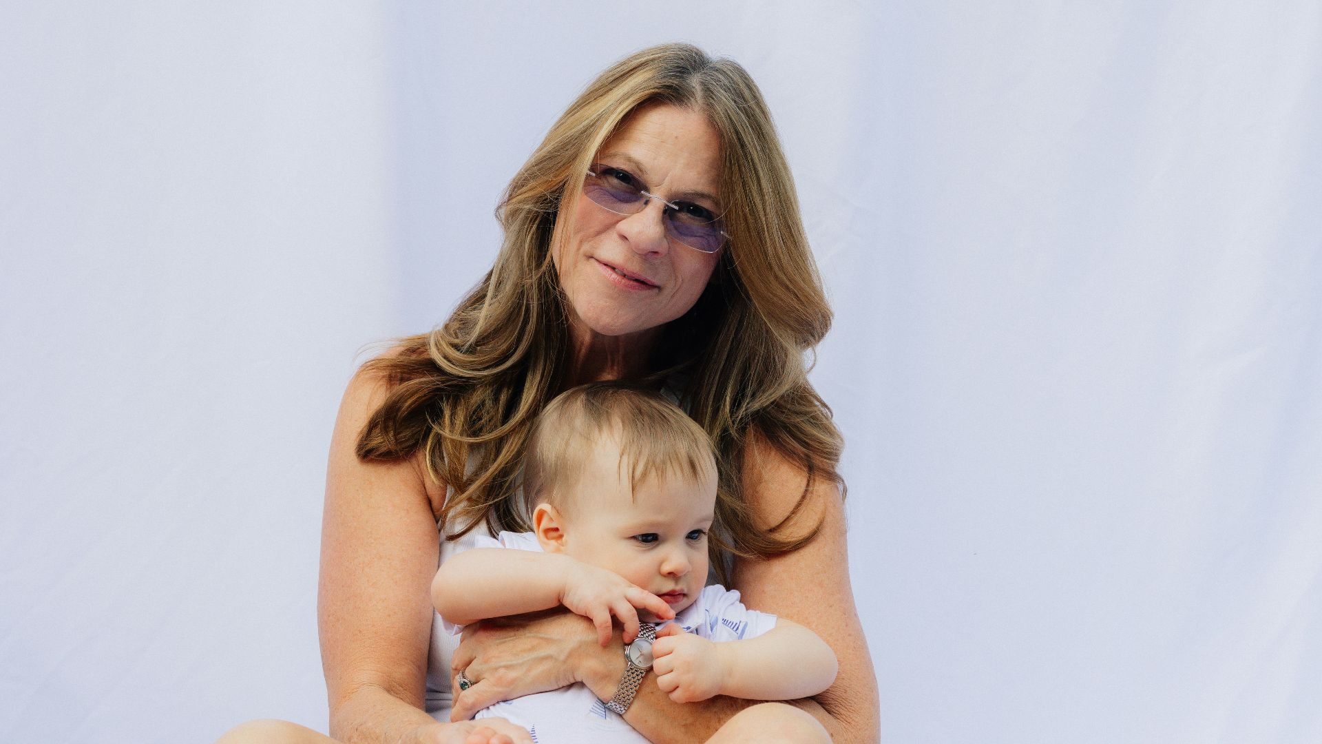 Woman holding a baby on a white background