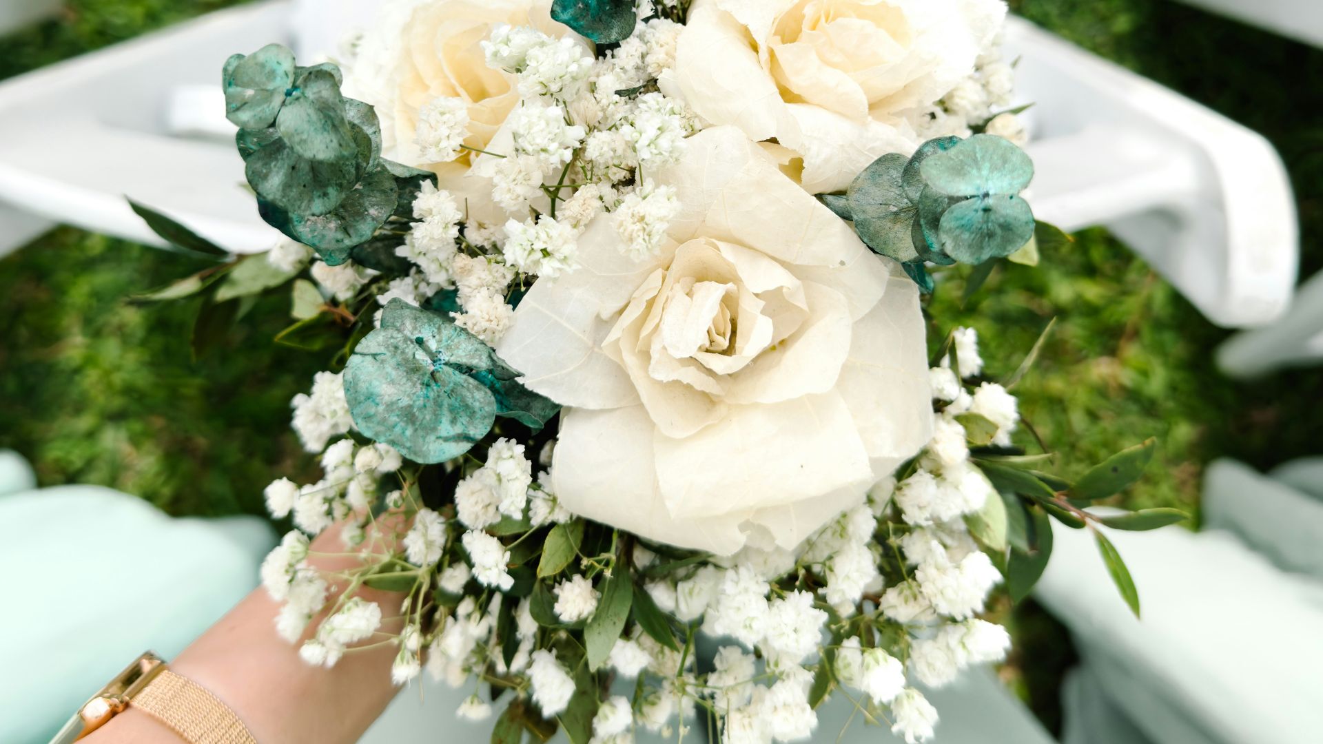 a bouquet of flowers sitting on top of a white chair